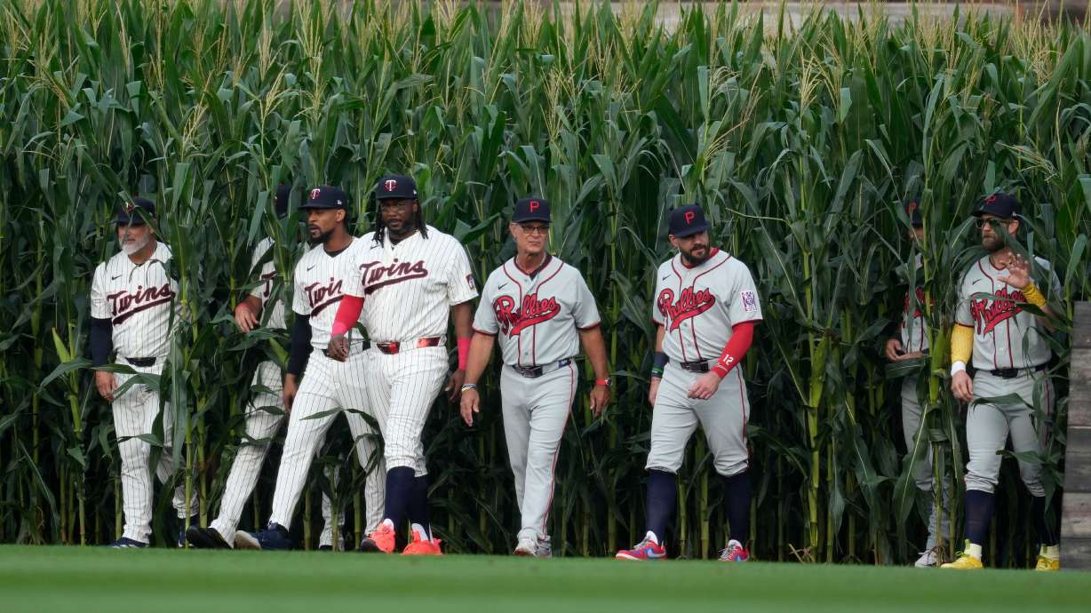 Players walk onto the field before a baseball game between the Minnesota Twins and the Philadelphia Phillies at the Field of Dreams movie site, Thursday, Aug. 13, 2026, in Dyersville, Iowa.