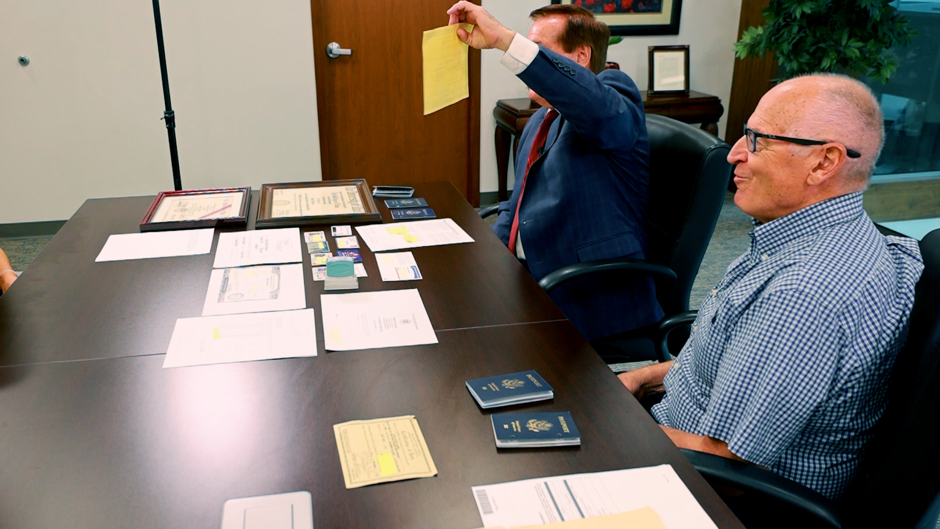Richard Glauser (left) holds up one of many documents he provided to the state in an effort to get a certified copy of his birth certificate.