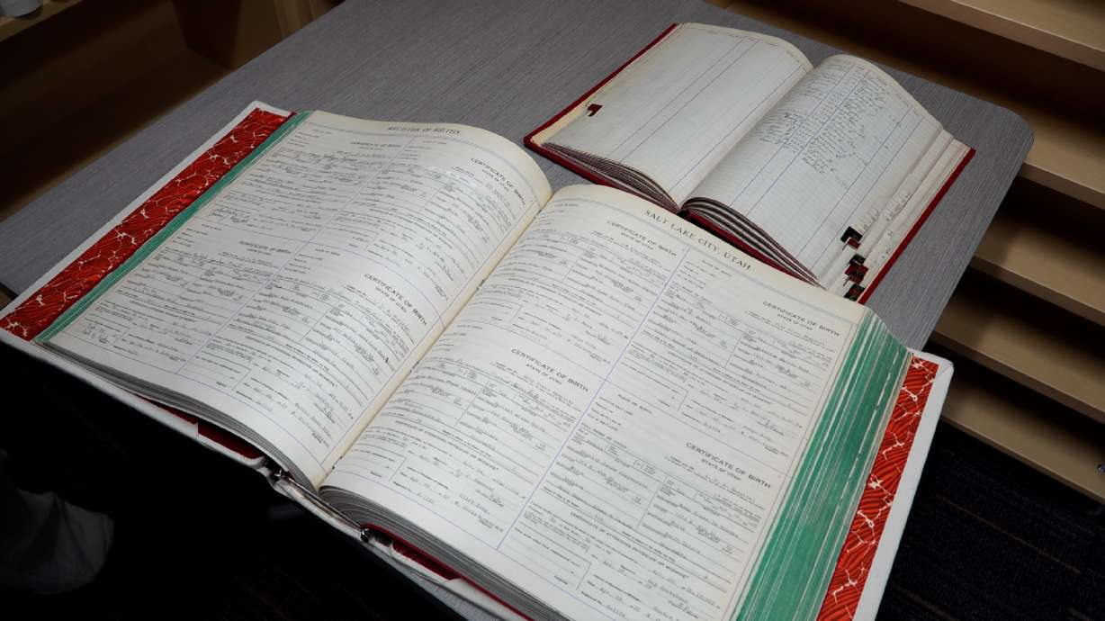 A Salt Lake County Health Department index book (top) from 1925 used to record changes to birth records and a record book (bottom) containing birth certificates from the same year.