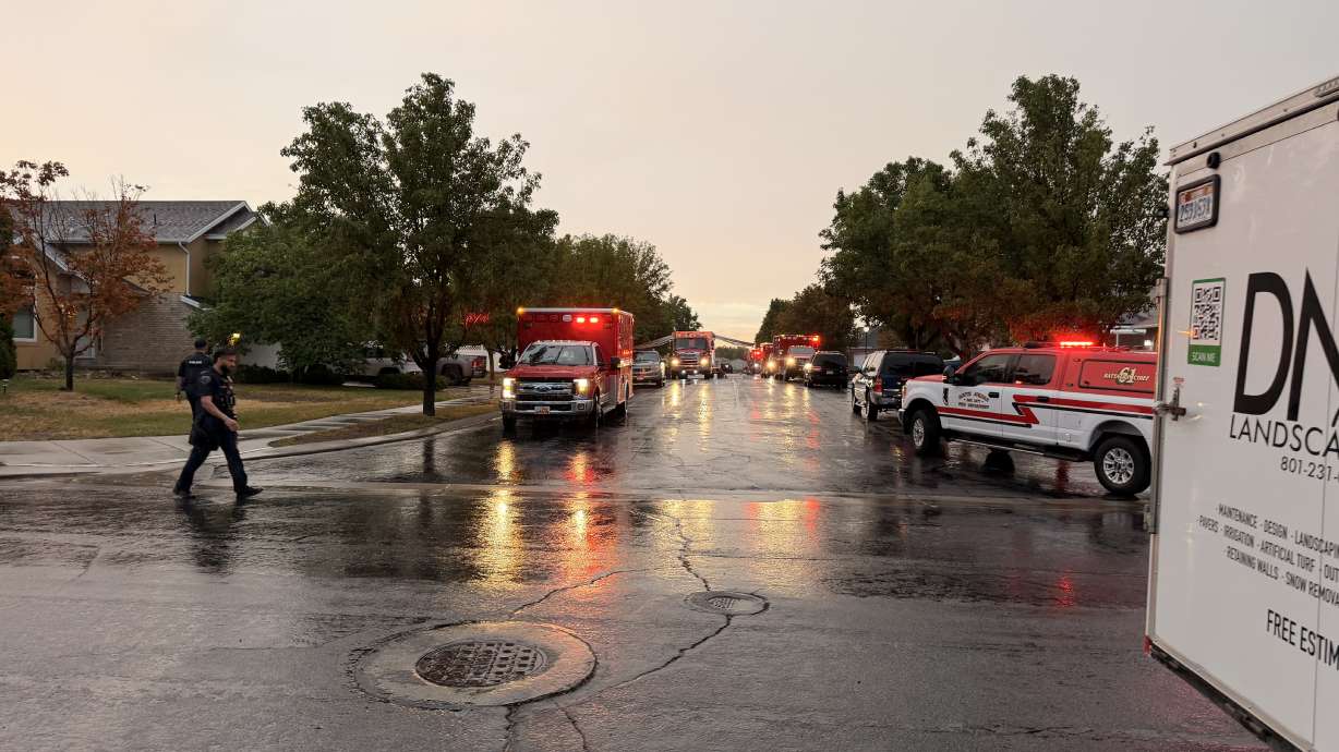 A house fire is pictured in West Jordan on Thursday. One man was hospitalized in critical condition.