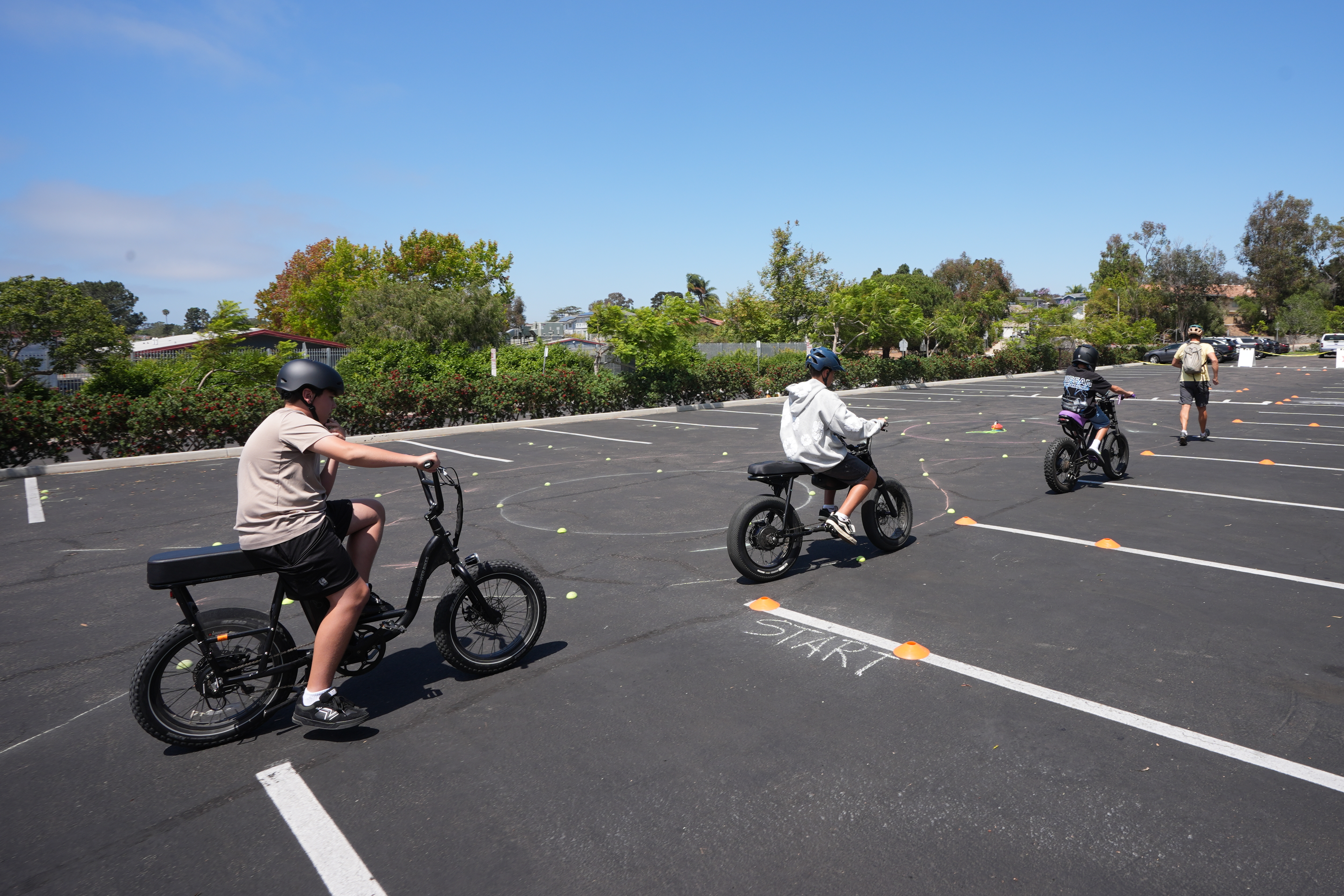 A group of kids ride e-bikes during an e-bike safety and training class Saturday in San Diego.