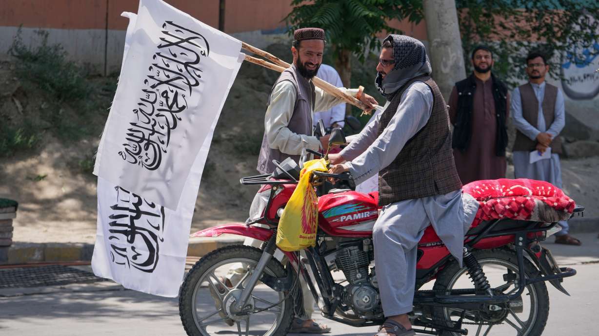 A man offers Taliban flags for sale ahead of celebrations marking the fifth anniversary of the U.S. withdrawal from Afghanistan and the start of Taliban rule, in Kabul, Afghanistan, Thursday.