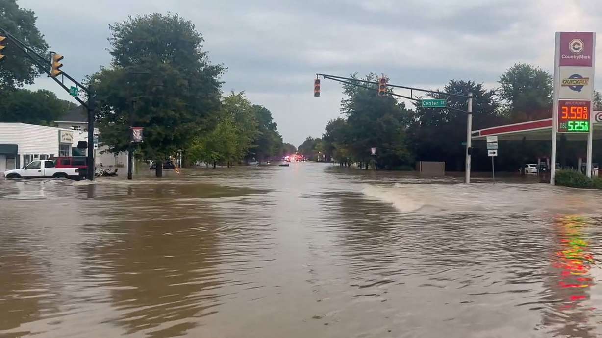 A flooded road in Cambridge City, Indiana shows the disastrous flooding that is drenching the Midwest for an eighth straight day, with officials reporting at least six deaths across Indiana, and more storms continuing to roll through Sunday.