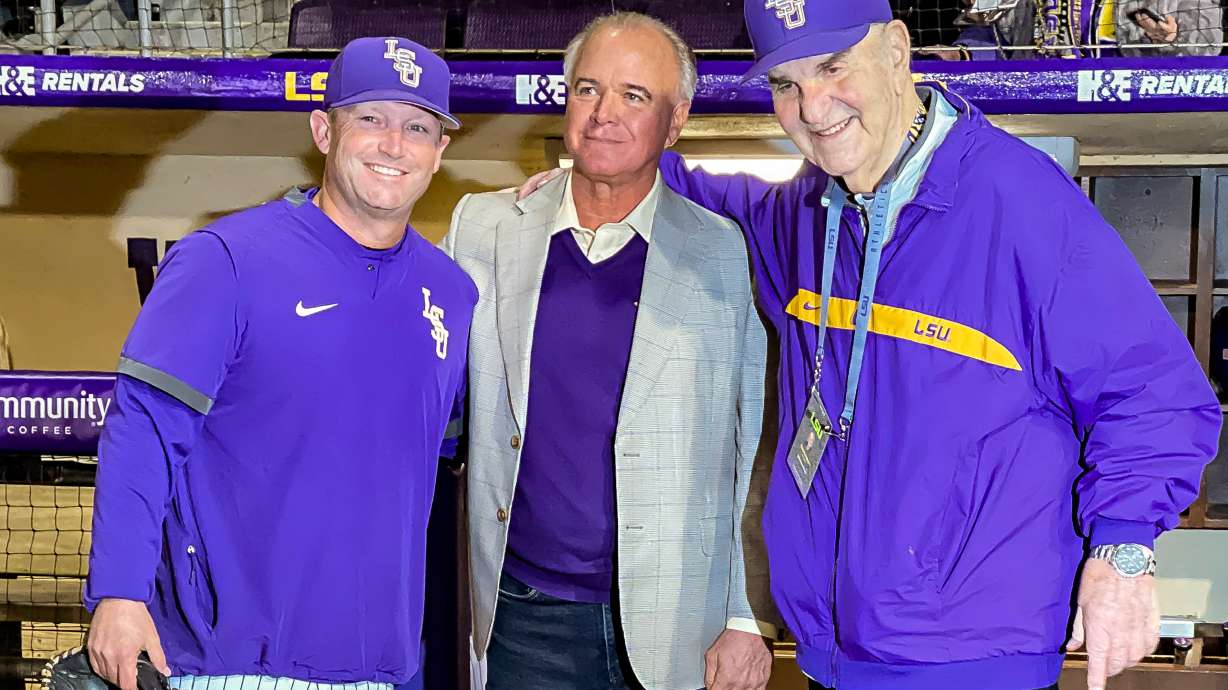 FILE - LSU head coach Jay Johnson, left, smiles with retired head coach Paul Mainieri, and head coach Skip Bertman before an NCAA baseball game against Maine on Feb. 18, 2022, in Baton Rouge,