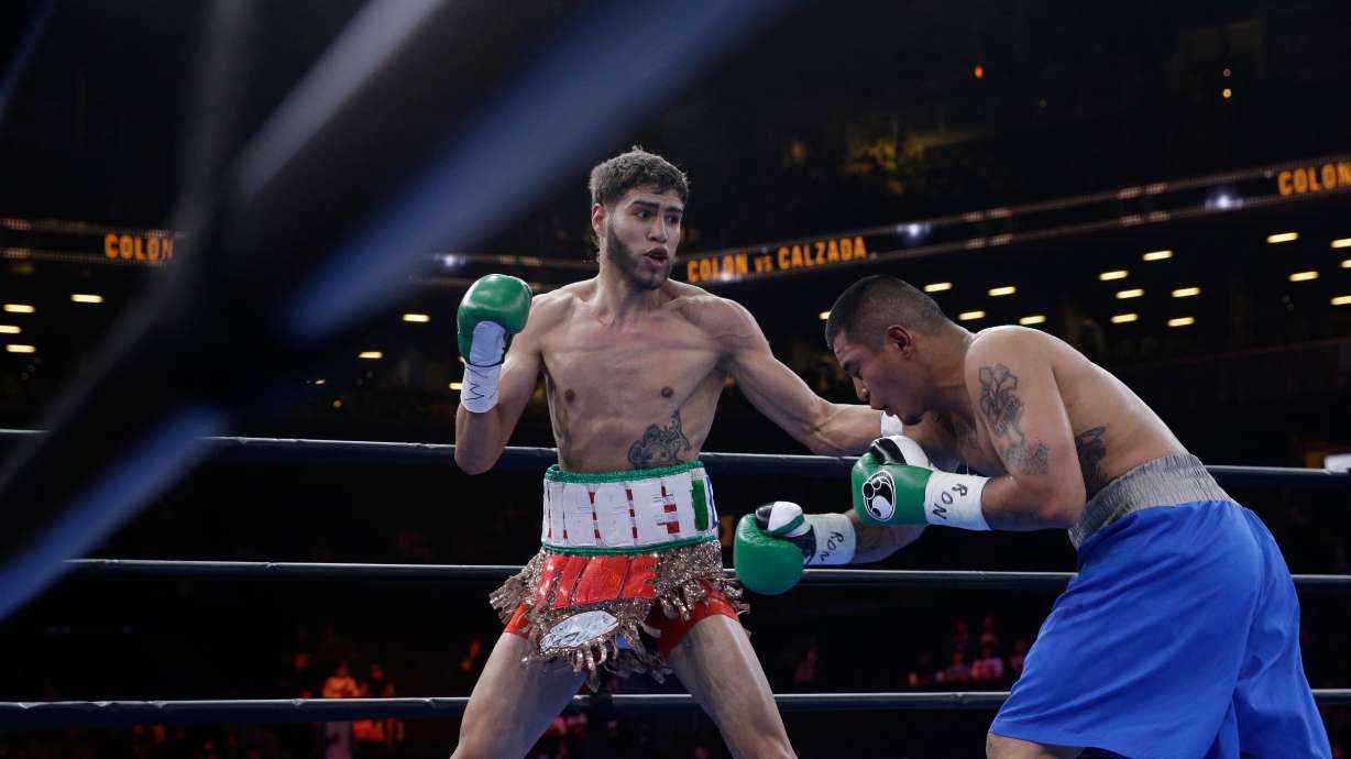 FILE - Prichard Colon, left, exchanges punches with Daniel Calzada during a junior middleweight title boxing match, Saturday, April 11, 2015, at New York. Colon won by TKO.