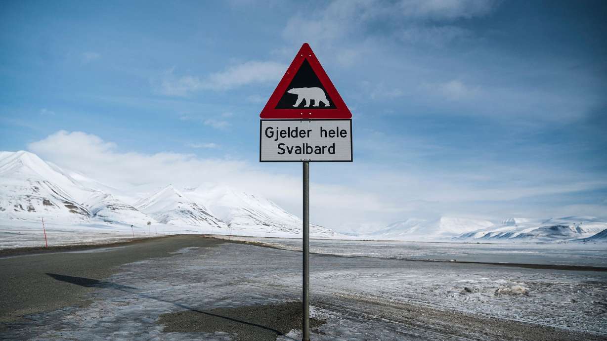 A warning sign depicts a polar bear at the side of a road in Longyearbyen on the Svalbard Archipelago, Norway, on May 2, 2022.