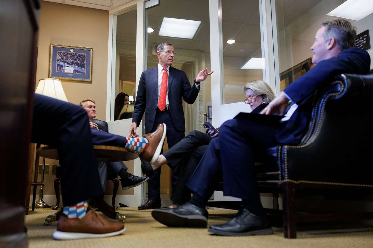 Senate Majority Whip John Barrasso R-Wyo., center, speaks to fellow Republicans ahead of a news conference on Capitol Hill on March 21, in Washington.
