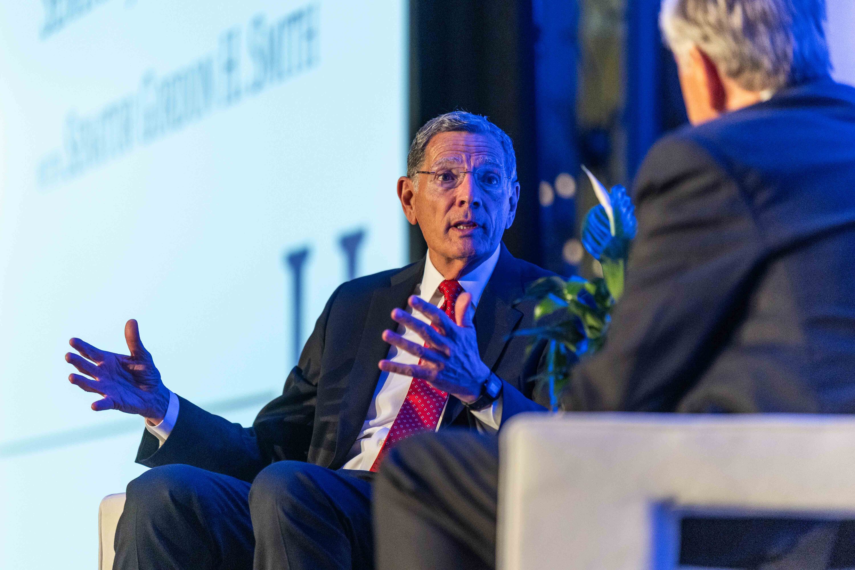 U.S. Senate Majority Whip John Barrasso, R-Wyo., left, speaks with former Oregon Sen. Gordon Smith at the annual Orrin G. Hatch Foundation Gala, where he received the Titan of Public Service Award, at the Grand America Hotel in Salt Lake City on Thursday, Aug. 13, 2026.