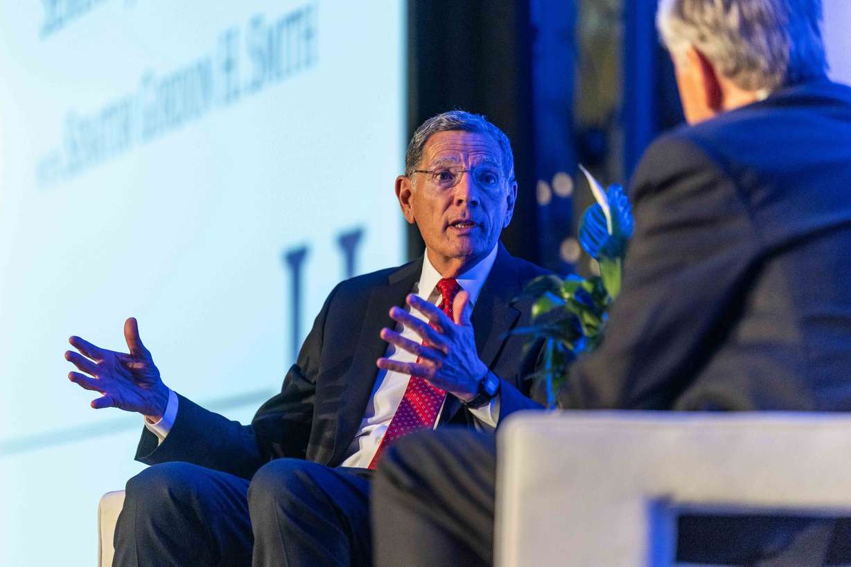 U.S. Senate Majority Whip John Barrasso, R-Wyo., left, speaks with former Oregon Sen. Gordon Smith at the annual Orrin G. Hatch Foundation Gala, where he received the Titan of Public Service Award, at the Grand America Hotel in Salt Lake City on Thursday, Aug. 13, 2026.