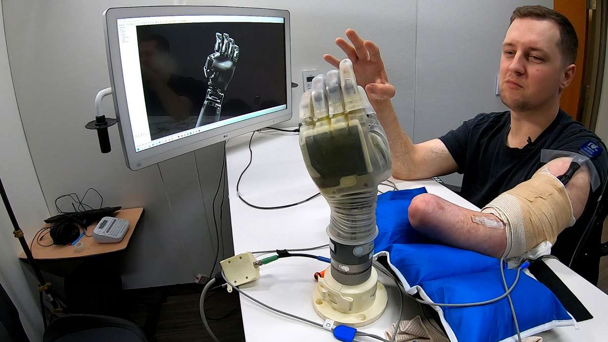 Alexander "Avi" Davidson, a therapist from Tampa, Florida, trains AI software to understand how his brain communicates with his hand on Feb. 3.