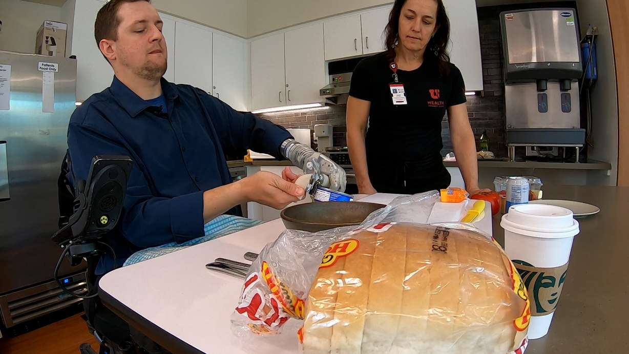 Alexander "Avi" Davidson, a therapist from Tampa, Florida, and occupational therapist Leanne Seckinger make a tuna melt sandwich on April 17.