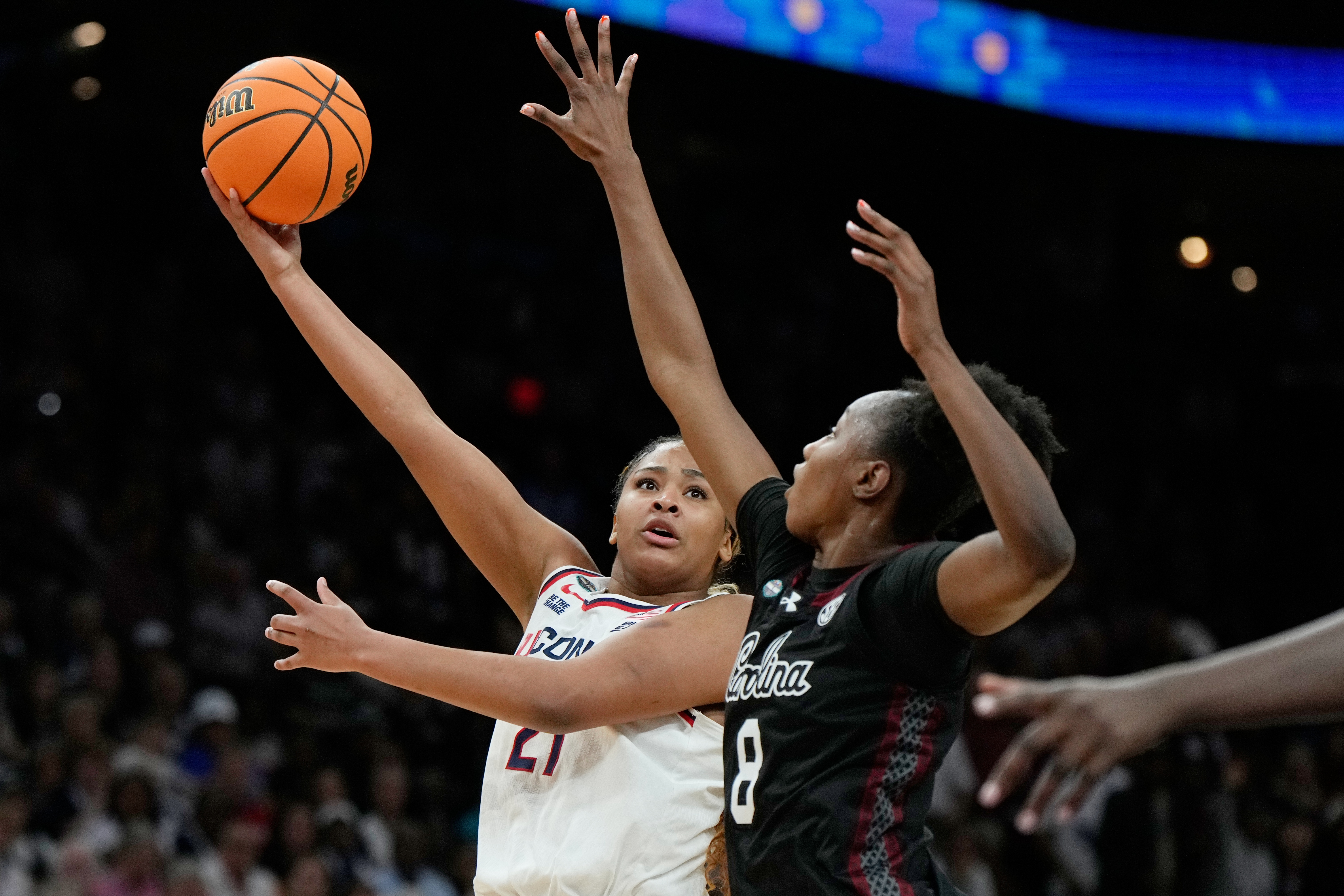 FILE - UConn forward Sarah Strong (21) shoots over South Carolina forward Joyce Edwards (8) during the second half of a woman's NCAA college basketball tournament semifinal game at the Final Four, April 3, 2026, in Phoenix. 