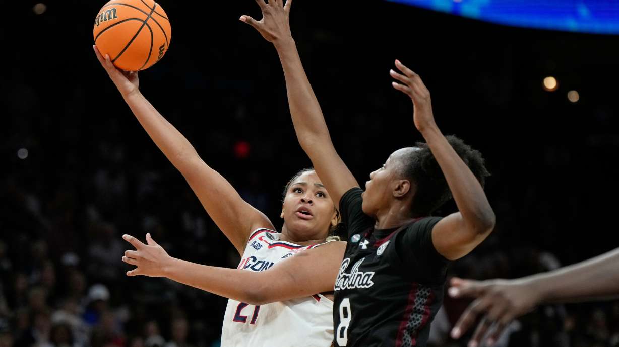 FILE - UConn forward Sarah Strong (21) shoots over South Carolina forward Joyce Edwards (8) during the second half of a woman's NCAA college basketball tournament semifinal game at the Final Four, April 3, 2026, in Phoenix.