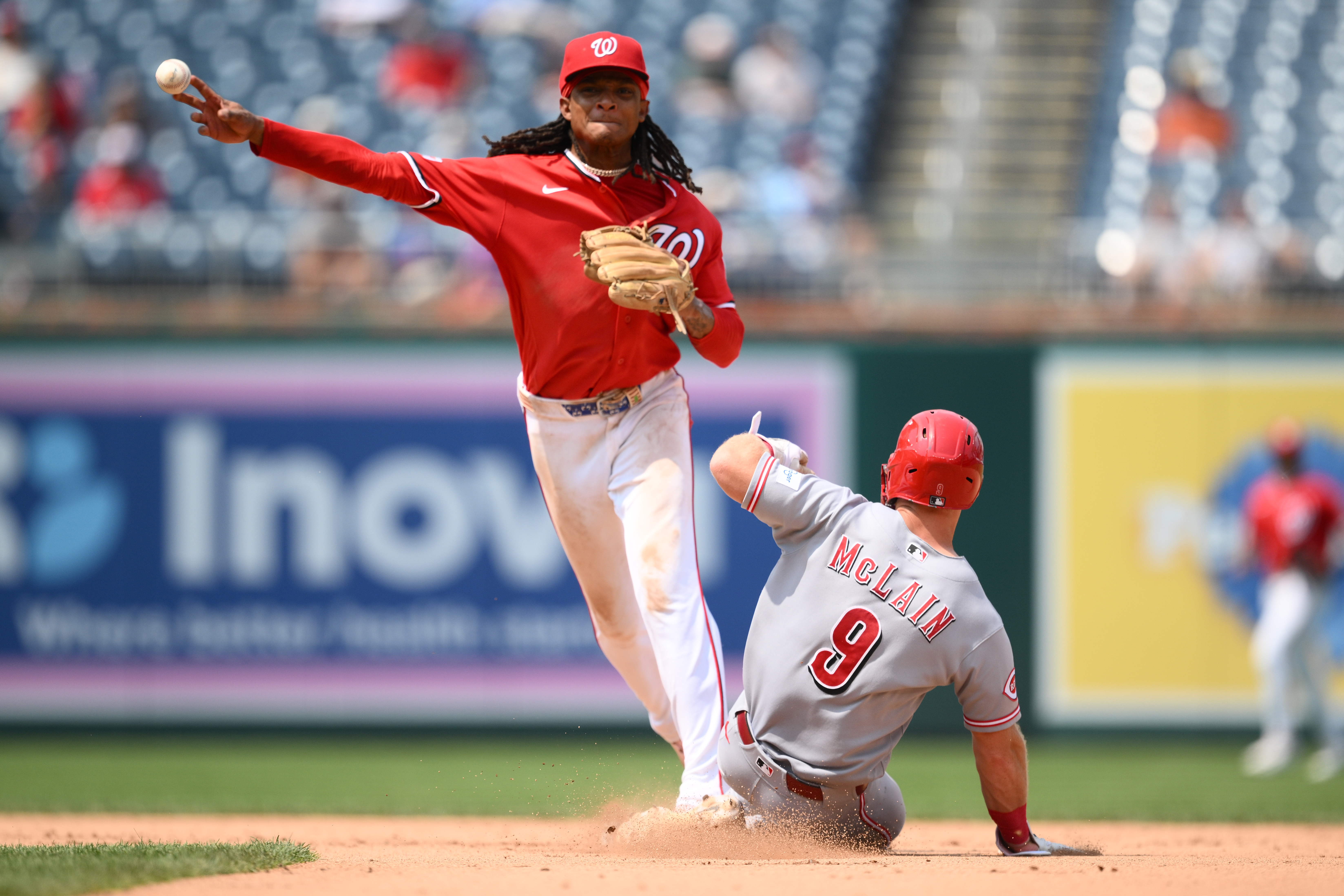 Cincinnati Reds' Matt McLain (9) is out at second base as Washington Nationals shortstop CJ Abrams, top, throws to first base to put out Reds' TJ Friedl for a double play during the eighth inning of a baseball game, Sunday, Aug. 9, 2026, in Washington. 