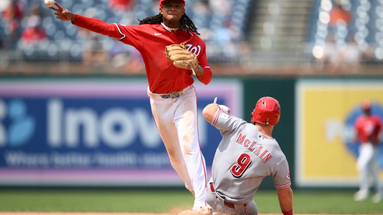 Cincinnati Reds' Matt McLain (9) is out at second base as Washington Nationals shortstop CJ Abrams, top, throws to first base to put out Reds' TJ Friedl for a double play during the eighth inning of a baseball game, Sunday, Aug. 9, 2026, in Washington.