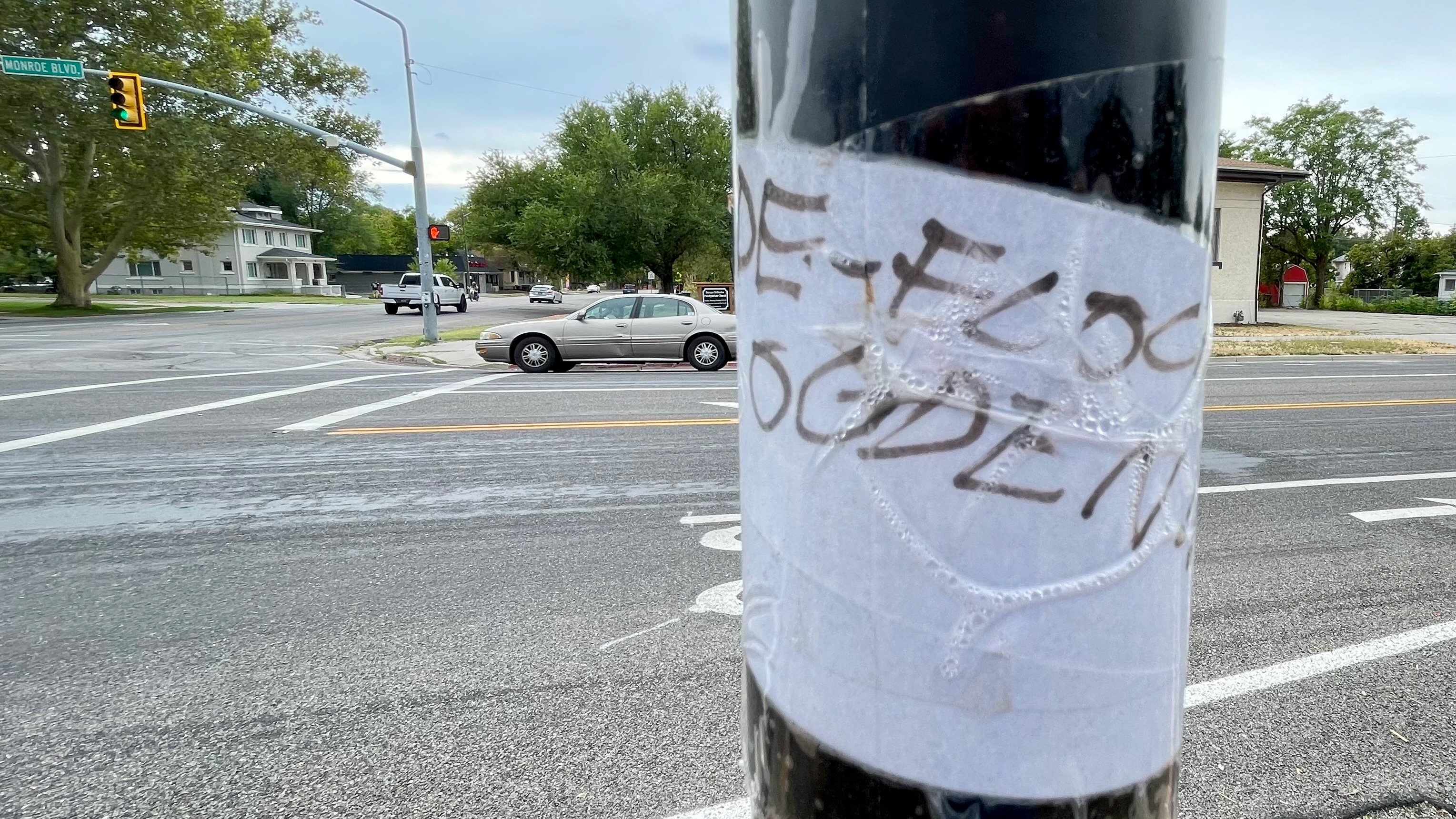 Davis County leaders approved an accord on the use of license plate readers as debate flares up on the topic. The photo shows a message reading "De-Flock Ogden" on the pole of a license plate reader on Monroe Boulevard in Ogden on Friday. Flock Safety makes the readers used in Ogden.