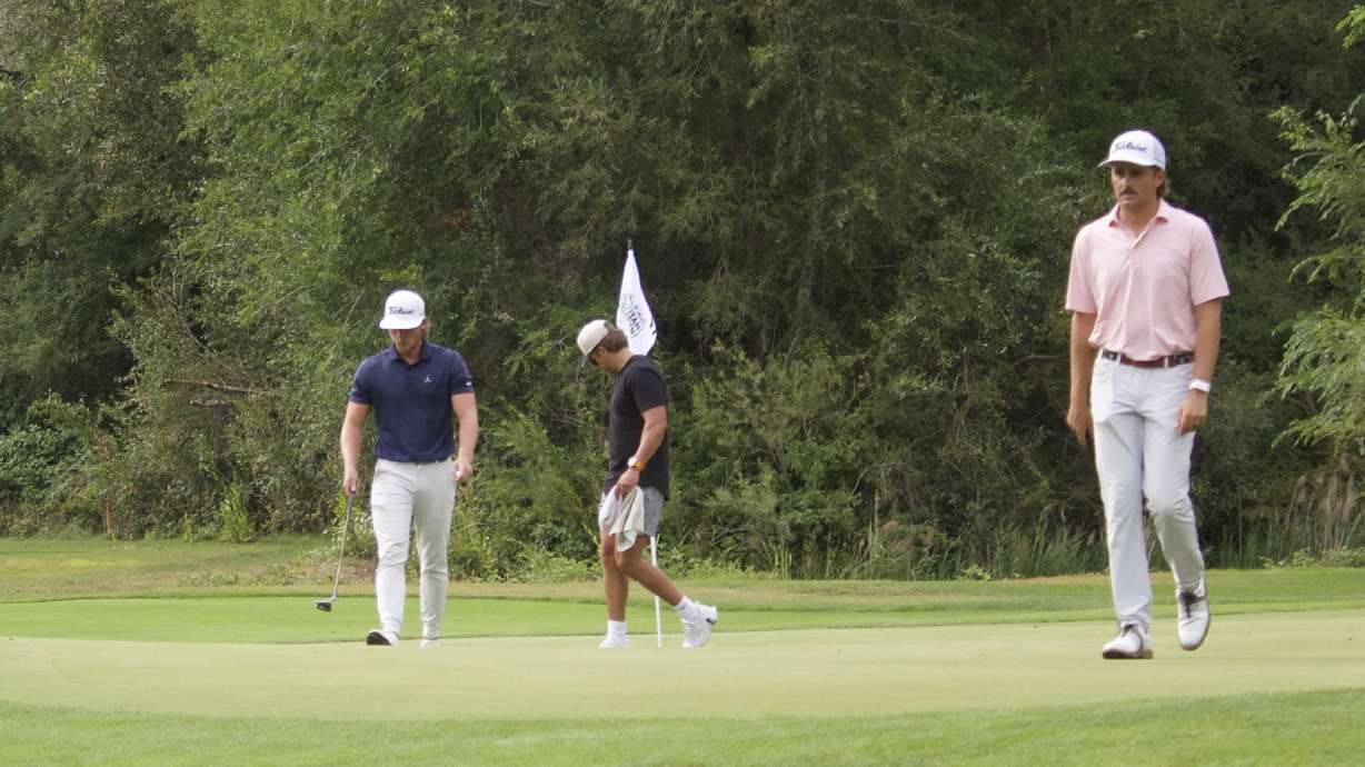 Former BYU golfer Carson Lundell, left, and Utah alum Braxton Watts walk off the No. 17 green during the first round of the Larry H. Miller Utah Open, Friday, Aug. 14, 2026 at Riverside Country Club in Provo.