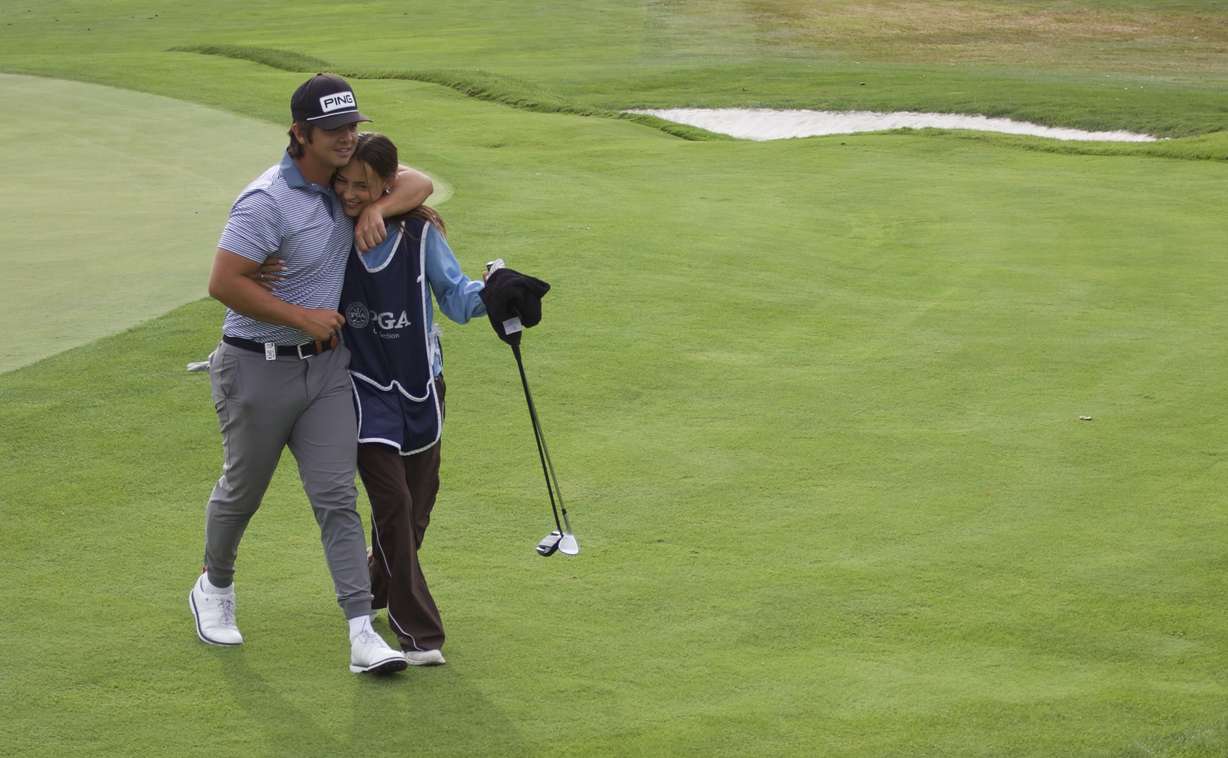 Former BYU golfer Tyson Shelley and his wife/caddy Hailee walk off the 18th green after the opening round of the Larry H. Miller Utah Open, Friday, Aug. 14, 2026 at Riverside Country Club in Provo.