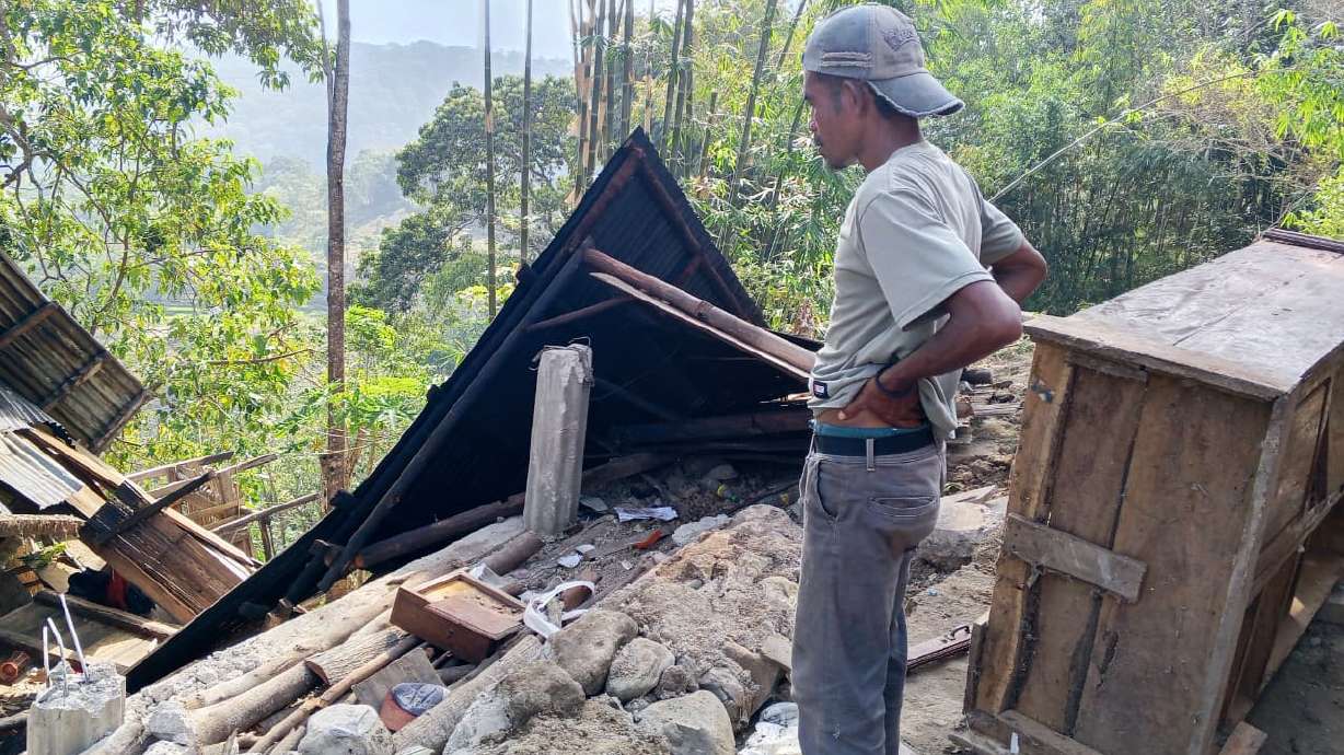 A man examines the damage to a building following an earthquake in East Manggarai, East Nusa Tenggara province, Indonesia, Saturday.