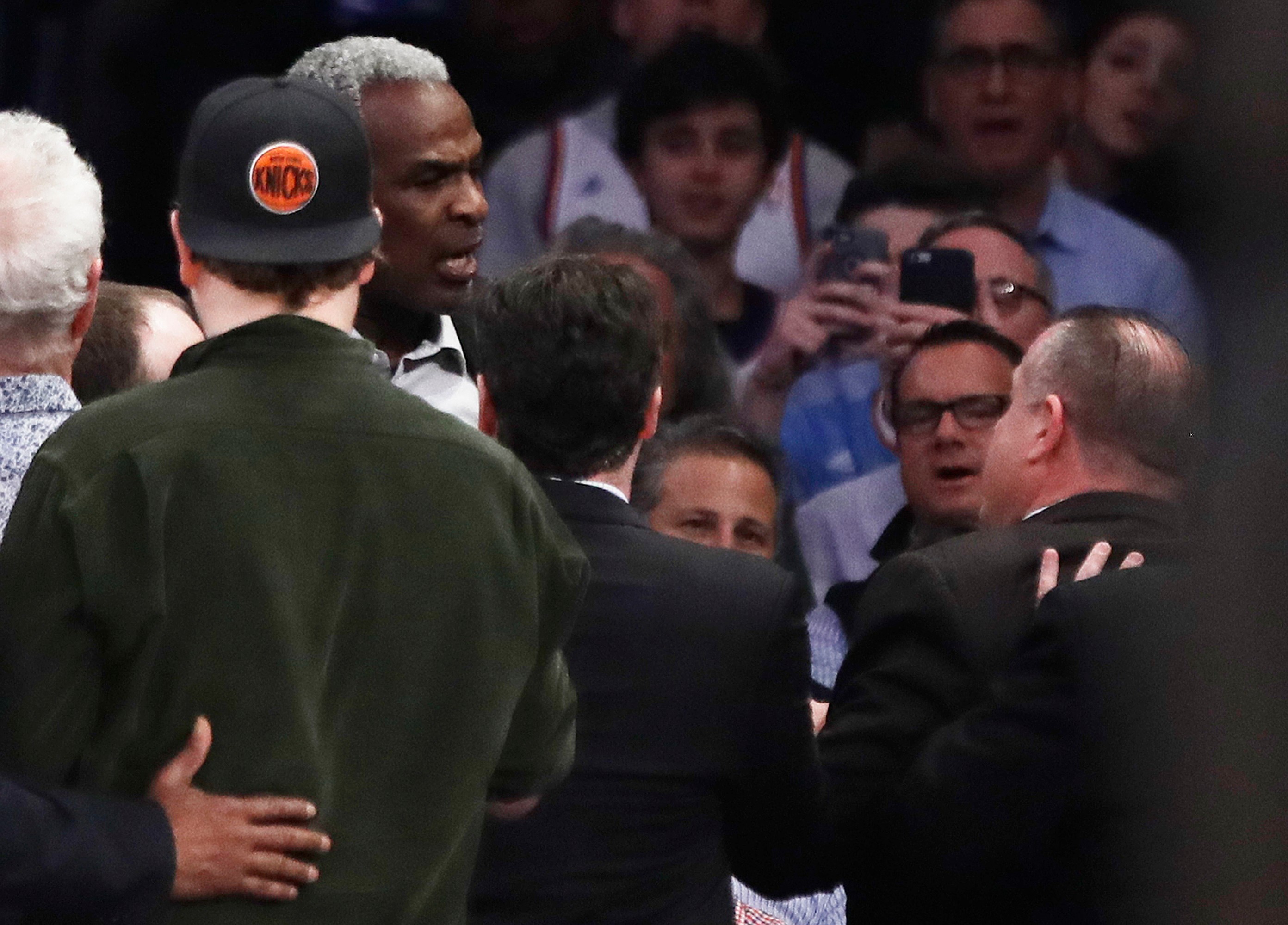 FILE - Former New York Knicks player Charles Oakley, rear left, exchanges words with a security guard during the first half of an NBA basketball game between the Knicks and the Los Angeles Clippers in New York on Feb. 8, 2017. 