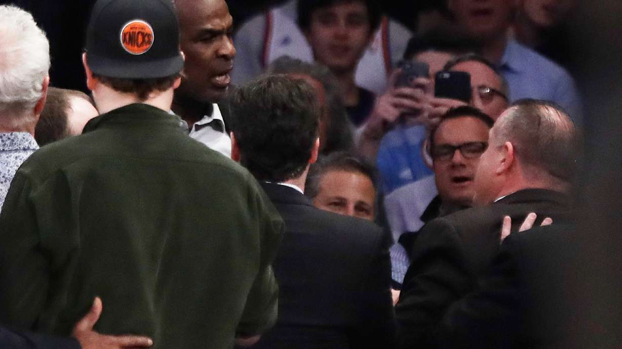 FILE - Former New York Knicks player Charles Oakley, rear left, exchanges words with a security guard during the first half of an NBA basketball game between the Knicks and the Los Angeles Clippers in New York on Feb. 8, 2017.