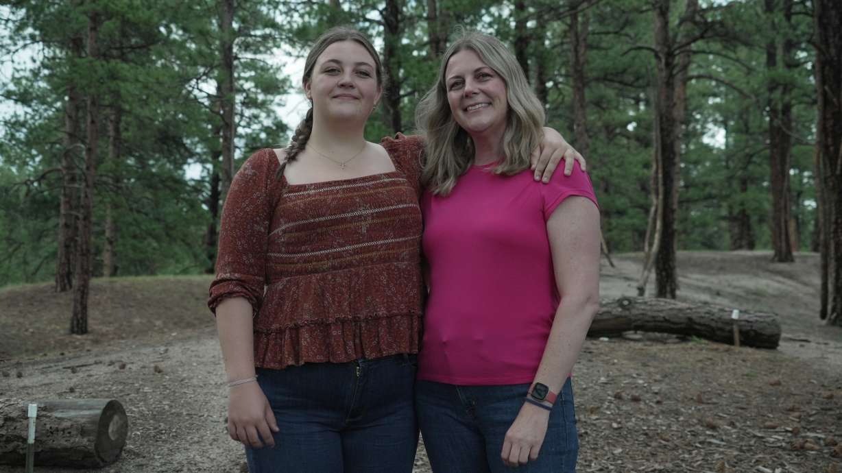 Charlotte Touzalin stands with her mother, Anne Schultz, July 10, in Elizabeth, Colo.