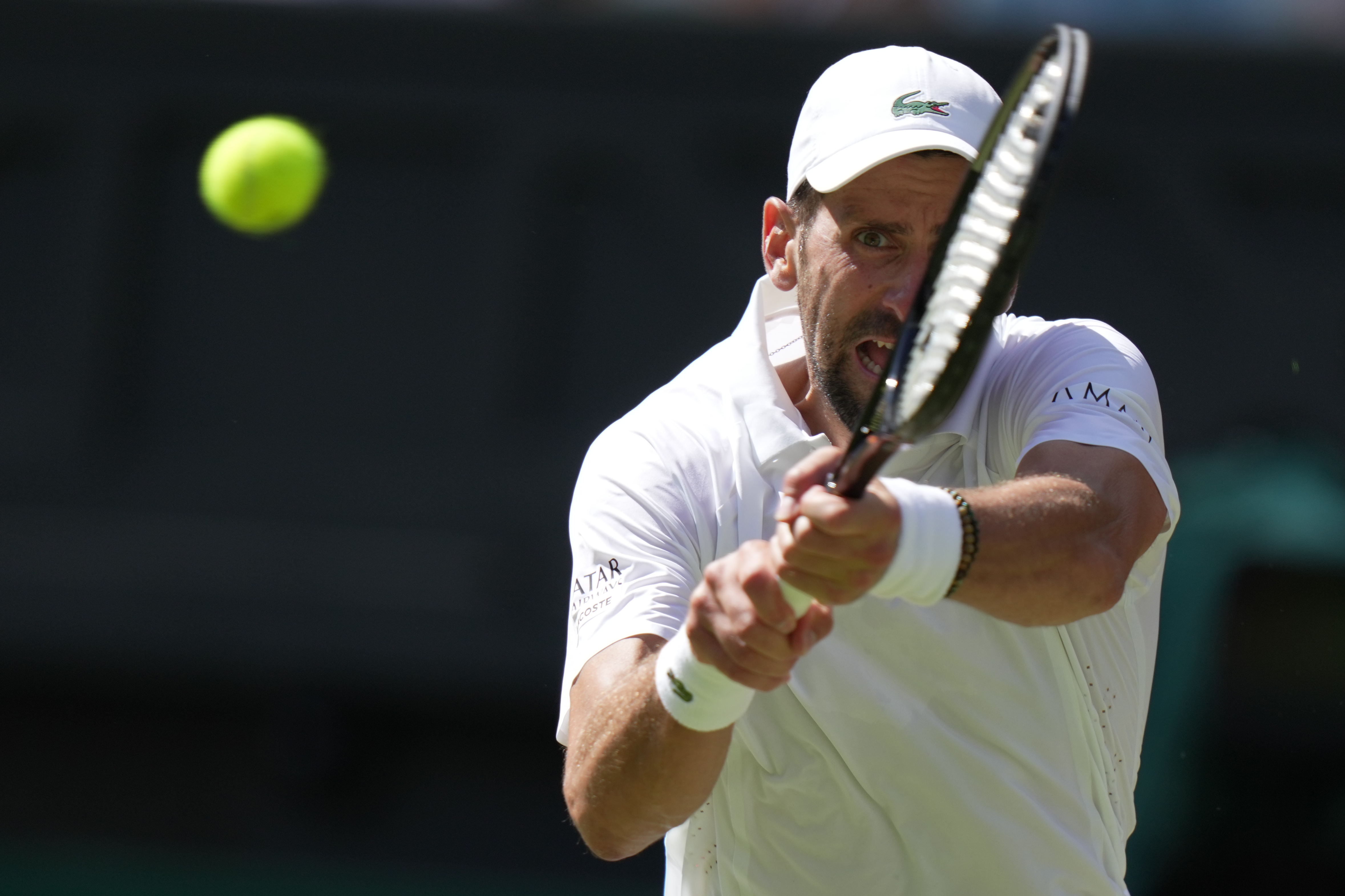 FILE - Novak Djokovic, of Serbia, returns the ball to Roman Saffiullin, of Russia, in their fourth round men's singles match at the Wimbledon Tennis Championships in London, July 5, 2026. 