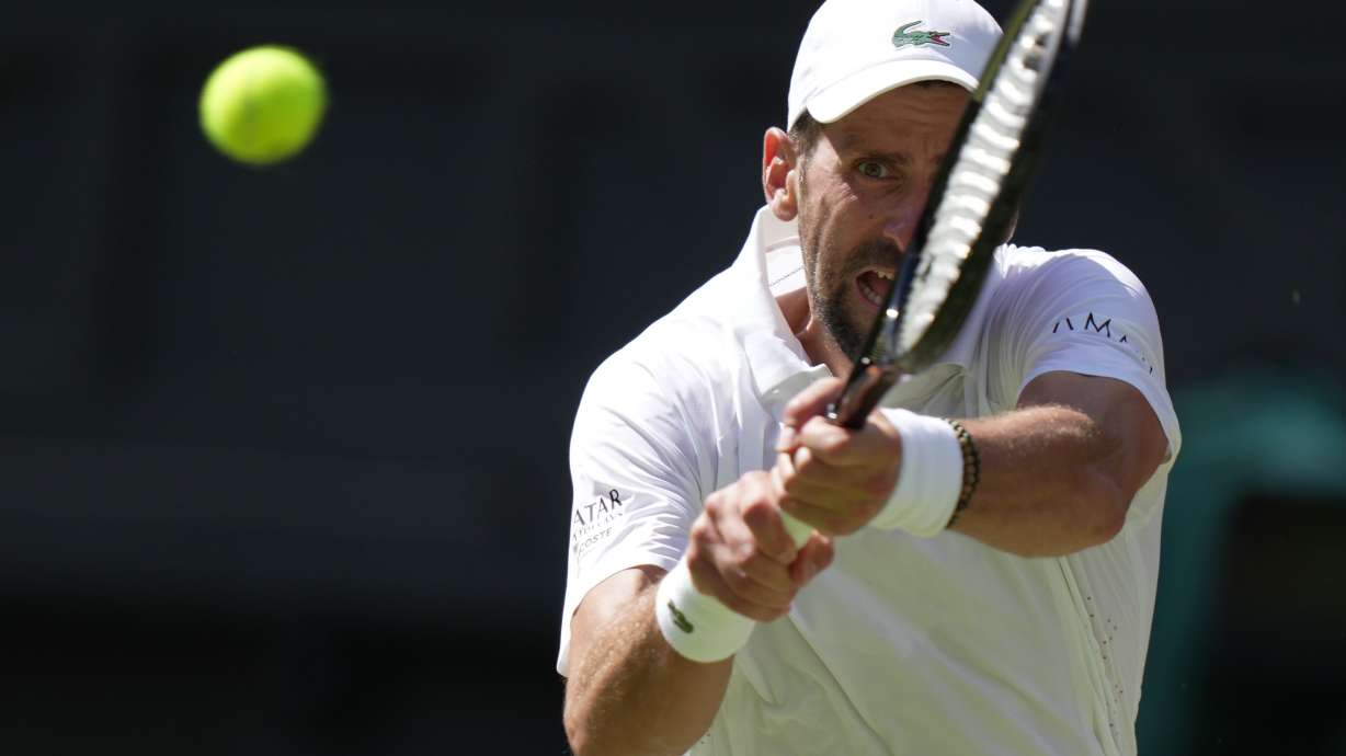 FILE - Novak Djokovic, of Serbia, returns the ball to Roman Saffiullin, of Russia, in their fourth round men's singles match at the Wimbledon Tennis Championships in London, July 5, 2026.