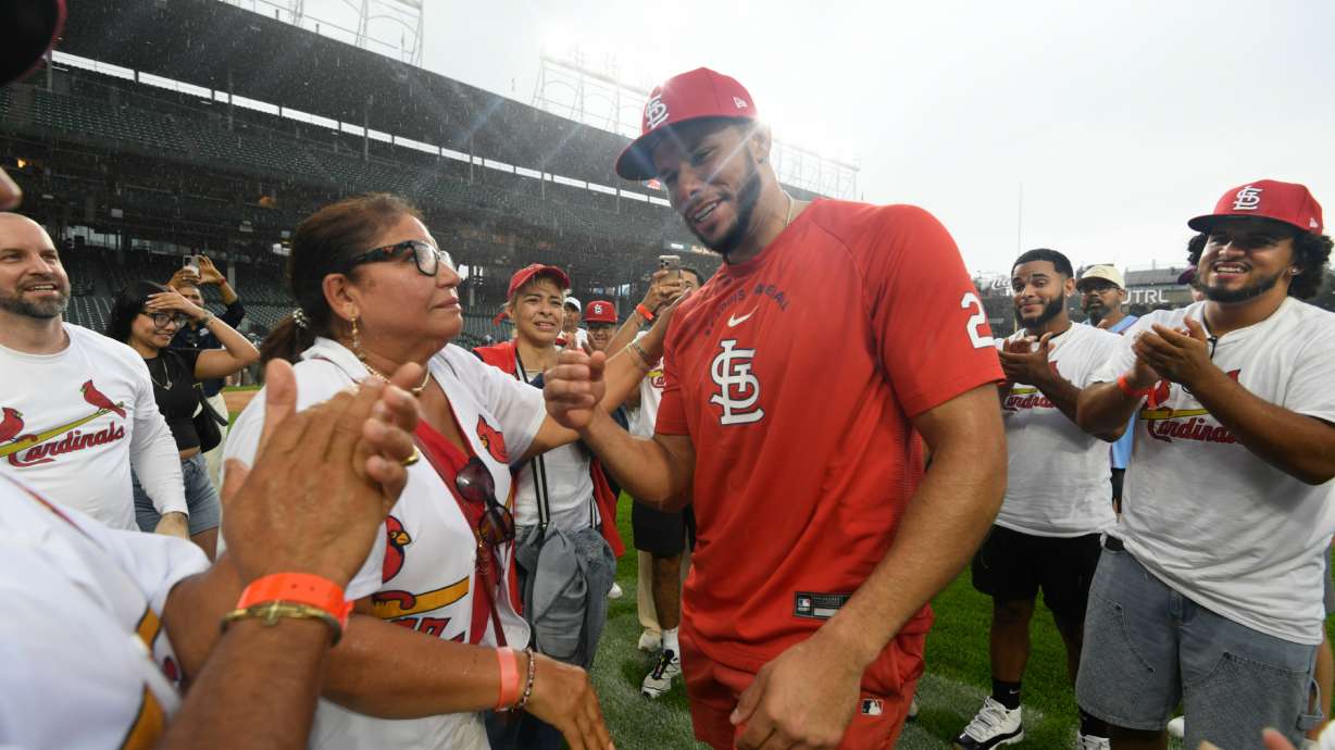 St. Louis Cardinals' Joshua Baez, right, celebrates with his mother Yris Carmen Baez, left, after defeating the Chicago Cubs in a baseball game in Chicago, Saturday, Aug. 15, 2026.