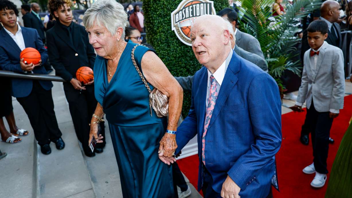 Veteran NBA referee and 2026 inductee Joey Crawford, right, recognizes his image on the columns of Symphony Hall as he enters the 2026 Naismith Basketball Hall of Fame induction ceremony Saturday, Aug. 15, 2026, in Springfield, Mass.