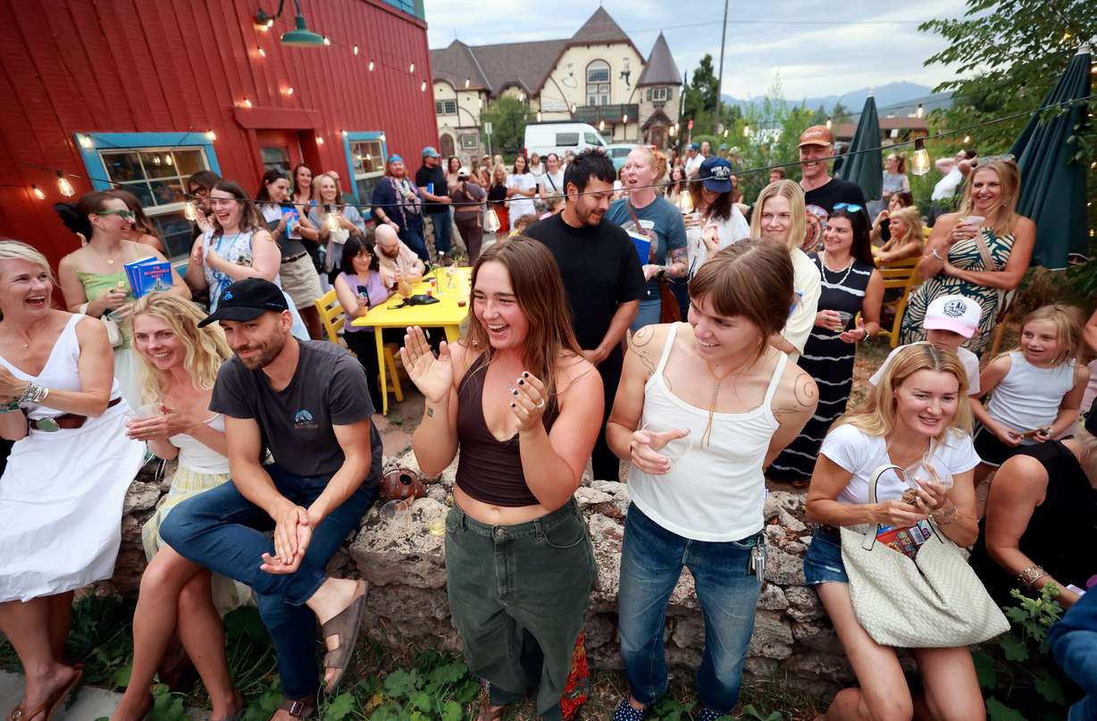 Attendees applaud after Claire Carusillo finished a reading at a book release event for her novel “The Responsible Party,” at Storyboard book, skate and coffee shop in Midway on Aug. 10. Carusillo recently opened Storyboard with Galen DeKemper.