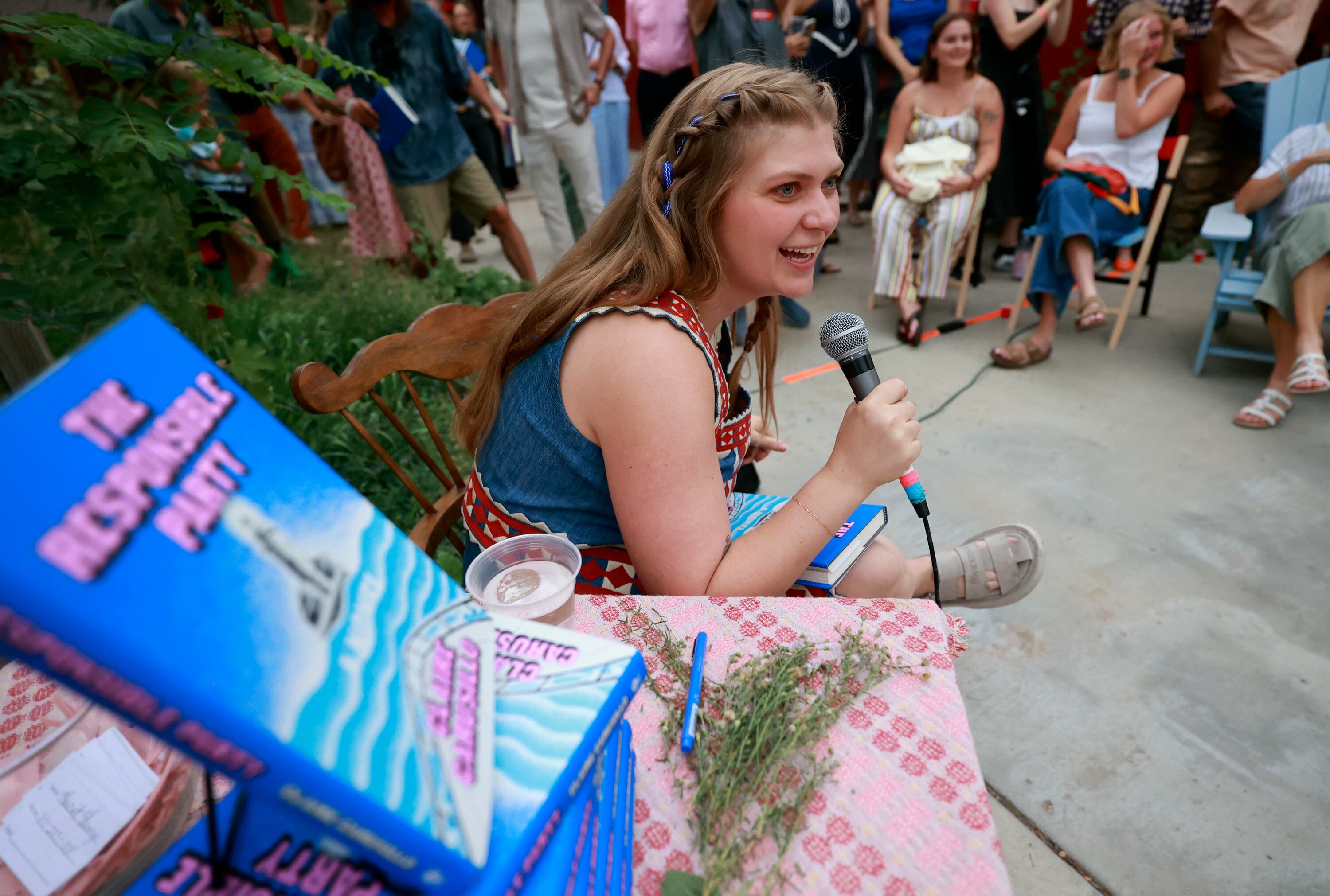 Claire Carusillo talks to attendees after giving a reading at a book release event for her novel “The Responsible Party,” at Storyboard book, skate and coffee shop in Midway on Aug. 10. Carusillo recently opened Storyboard with Galen DeKemper.