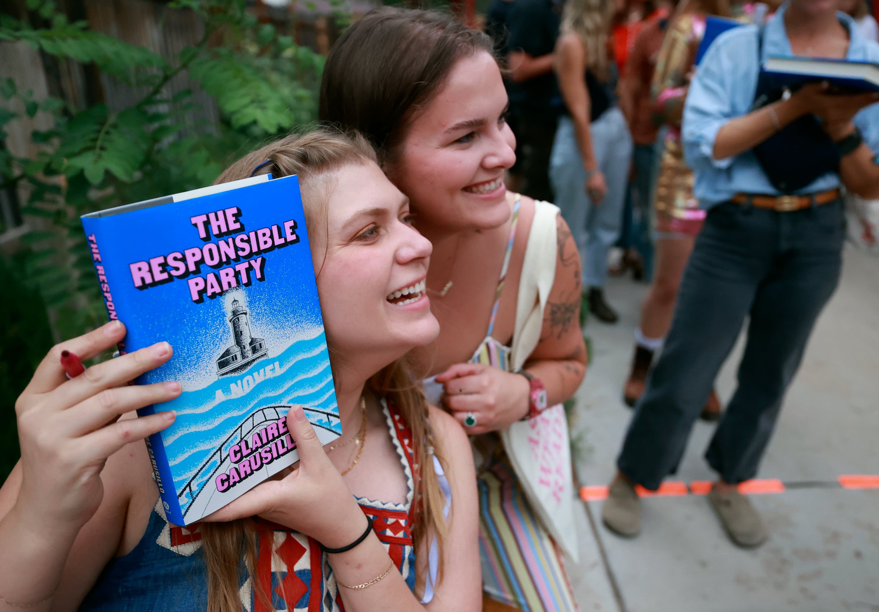 Claire Carusillo poses for a photo with Abbey Wright during a book release event for Carusillo’s novel “The Responsible Party,” at Storyboard book, skate and coffee shop in Midway on Aug. 10. Carusillo recently opened Storyboard with Galen DeKemper.