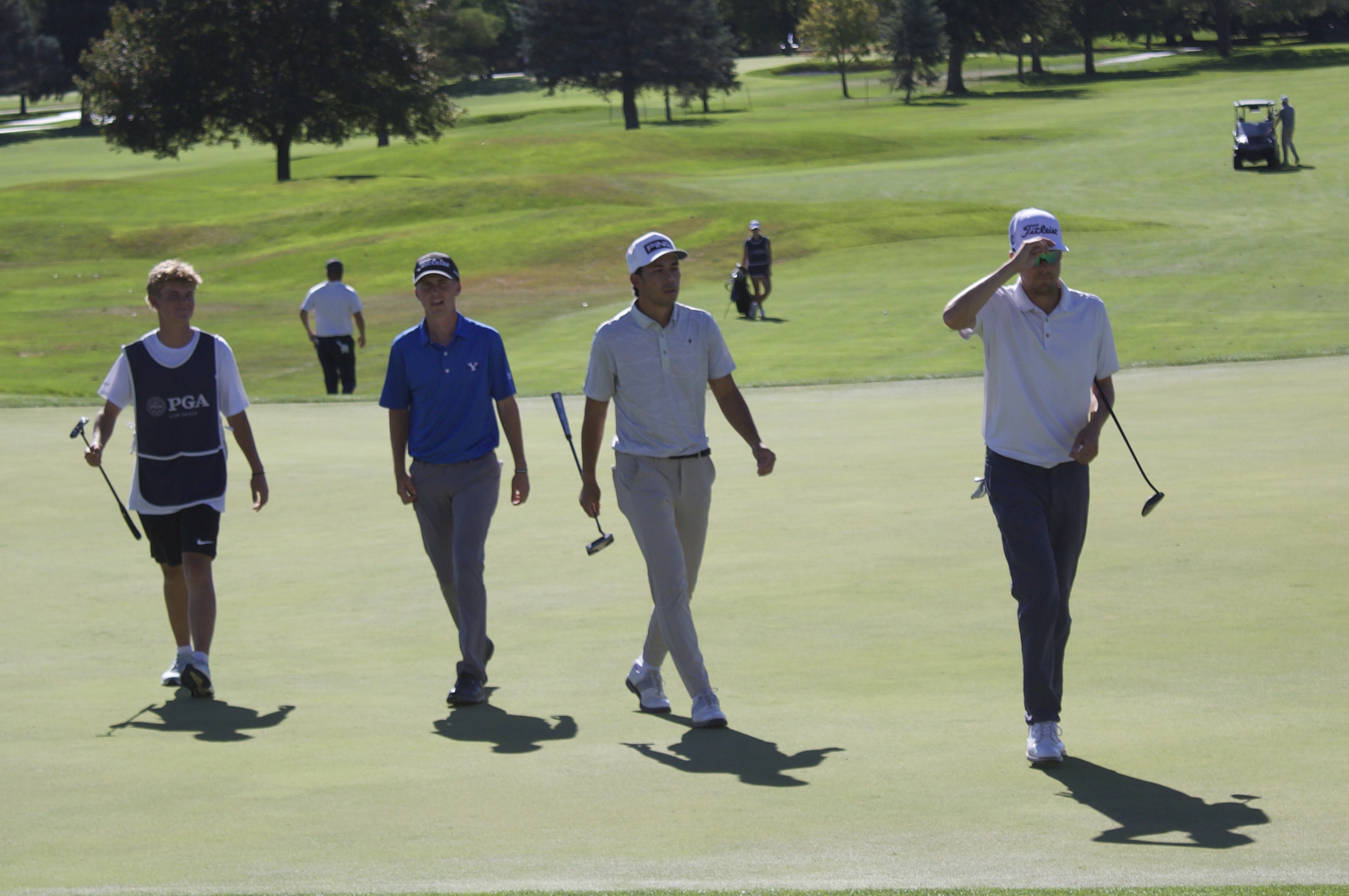 The group including former BYU golfer Rhett Rasmussen (right), Keanu Akina and Cooper Jones walks off the 18th hole after shooting 10-under at the 100th edition of the Larry H. Miller Utah Open, Saturday, Aug. 15, 2026 at Riverside Country Club in Provo.
