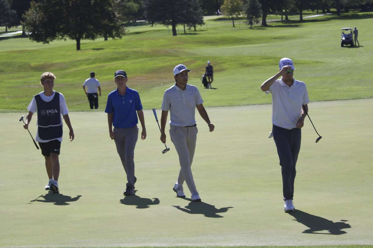 The group including former BYU golfer Rhett Rasmussen (right), Keanu Akina and Cooper Jones walks off the 18th hole after shooting 10-under at the 100th edition of the Larry H. Miller Utah Open, Saturday, Aug. 15, 2026 at Riverside Country Club in Provo.
