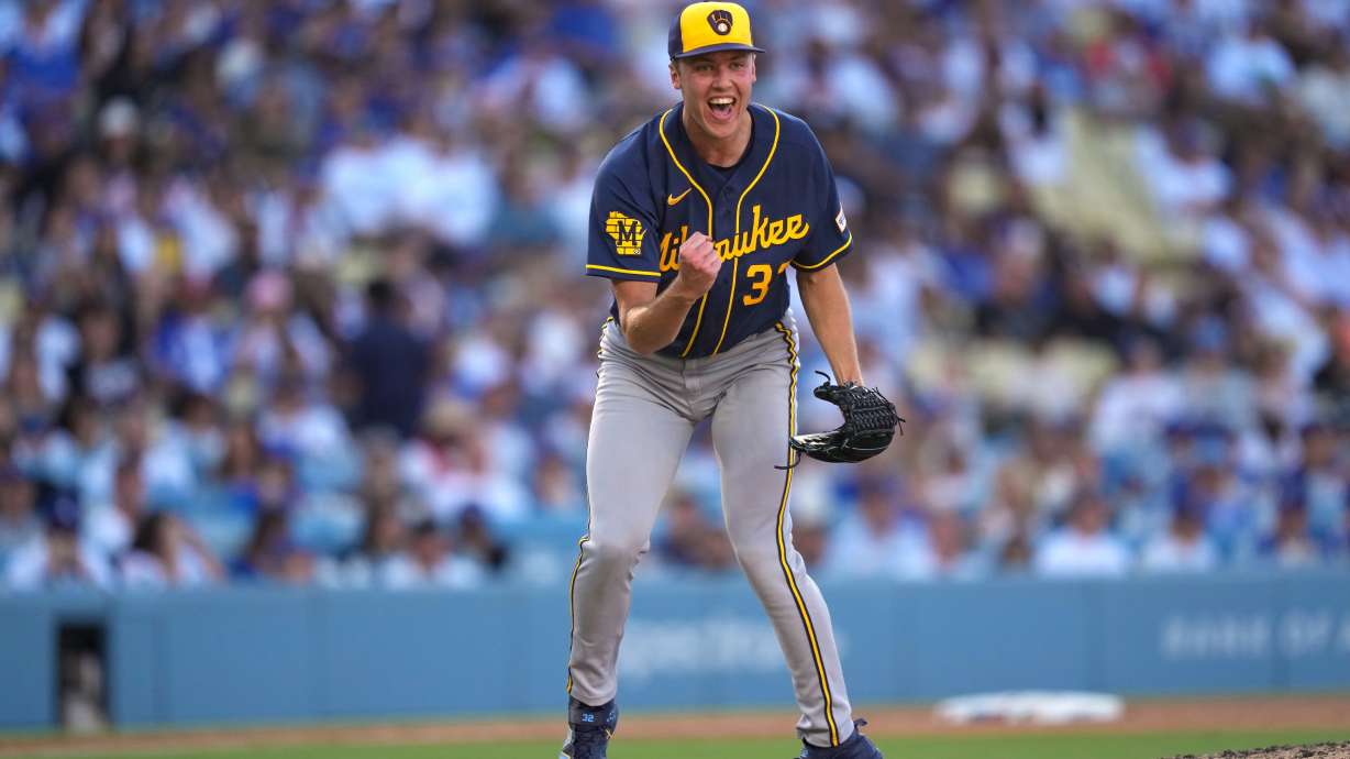 Milwaukee Brewers starting pitcher Jacob Misiorowski, left, celebrates after striking out Los Angeles Dodgers' Tommy Edman during the sixth inning of a baseball game Saturday, Aug. 15, 2026, in Los Angeles.