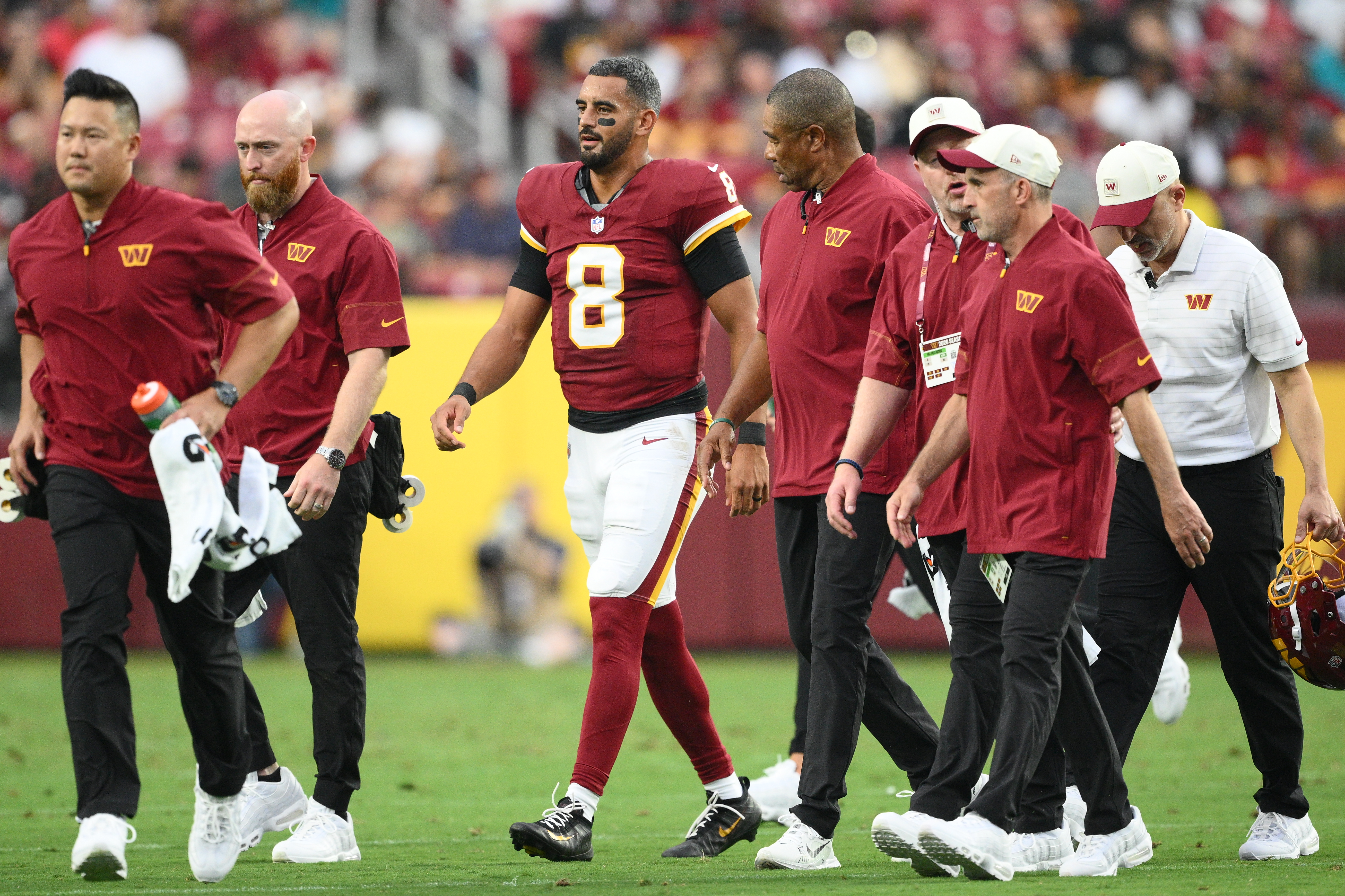 Washington Commanders quarterback Marcus Mariota (8) walks off the field during the first half of an NFL preseason football game against the Miami Dolphins, Friday, Aug. 14, 2026, in Landover, MD. 