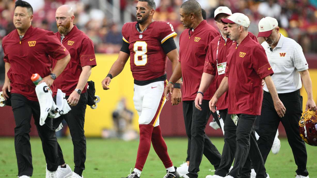 Washington Commanders quarterback Marcus Mariota (8) walks off the field during the first half of an NFL preseason football game against the Miami Dolphins, Friday, Aug. 14, 2026, in Landover, MD.