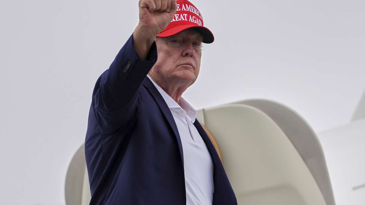 President Donald Trump gestures as he boards Air Force One at Morristown Airport on Sunday in Morristown, N.J.