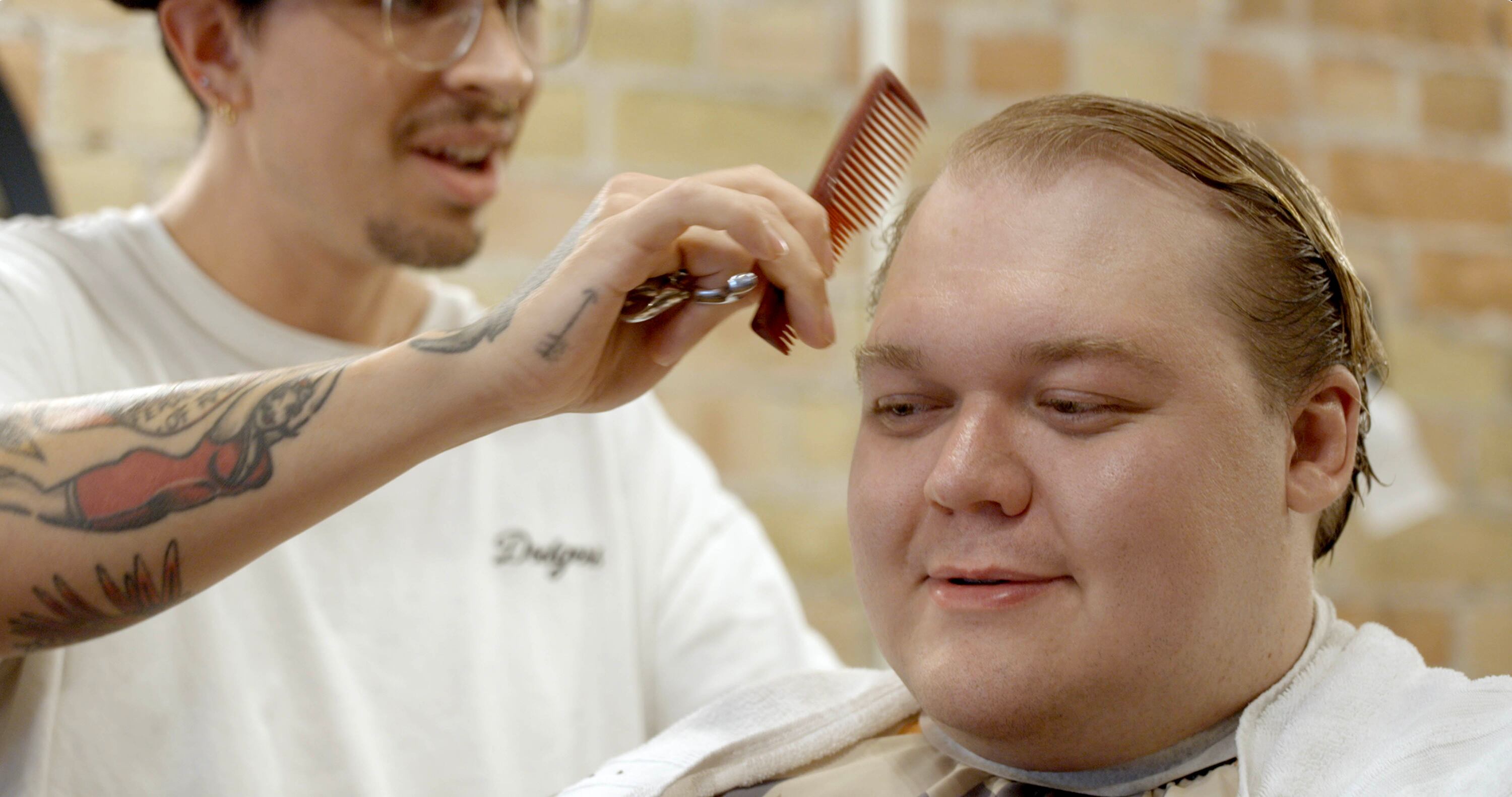 Ethan Van Valkenburg, who participated in a Utah-based dating campaign, gets his hair done.