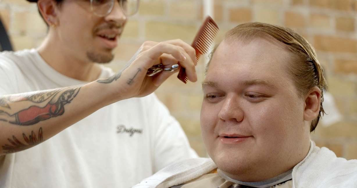 Ethan Van Valkenburg, who participated in a Utah-based dating campaign, gets his hair done.