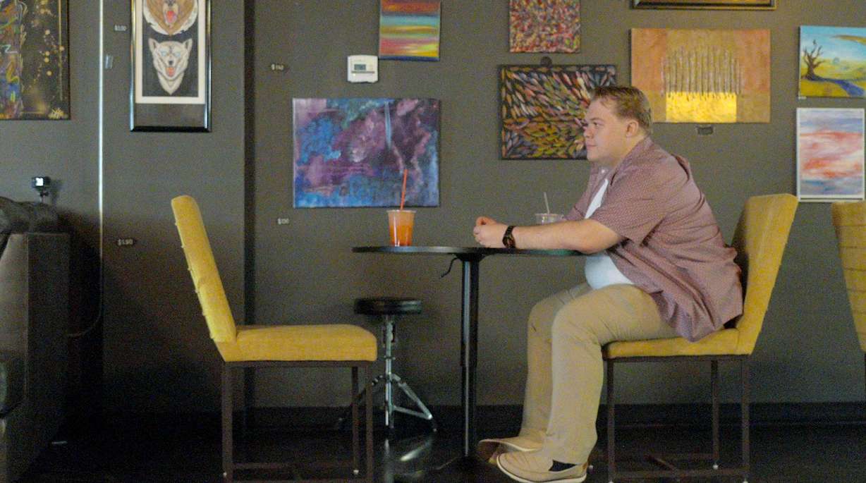 Ethan Van Valkenburg, who participated in a Utah-based dating campaign, sits at a coffee shop, waiting for one of his four dates to arrive.