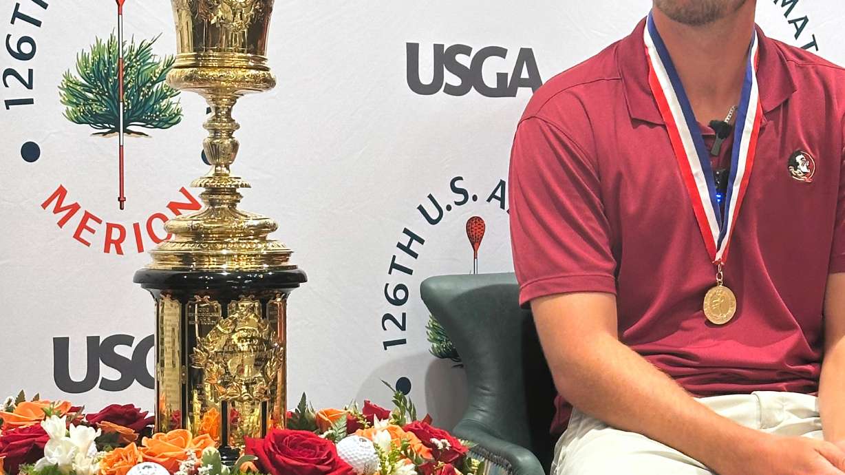 Jack Whaley admires his US Amateur golf championship trophy Sunday, Aug. 16, 2026, at Merion Golf Club in Ardmore, Pa.