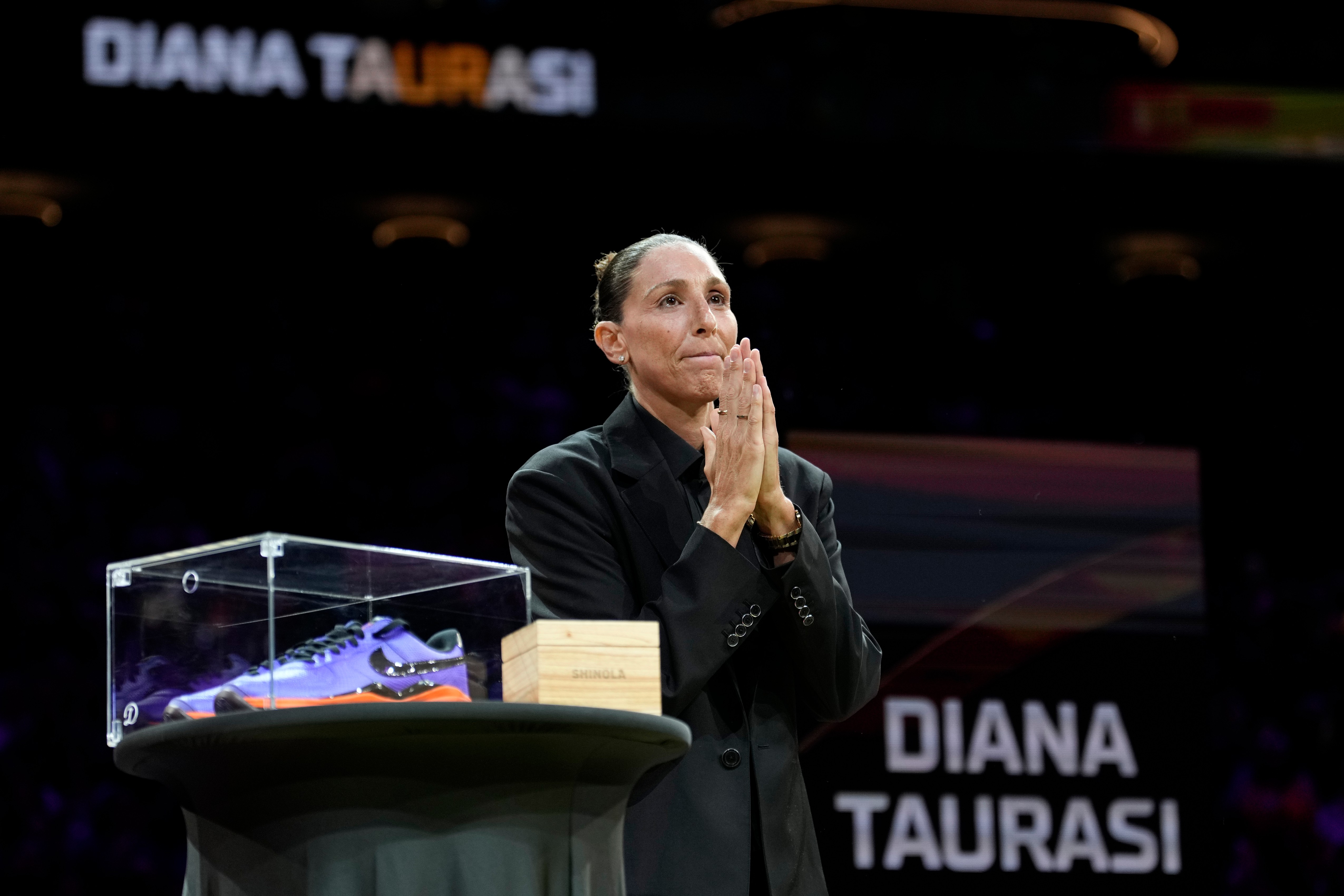 Retired WNBA Phoenix Mercury basketball player Diana Taurasi acknowledges the cheering crowd as she is honored during a halftime Ring of Honor ceremony Sunday, Aug. 16, 2026, in Phoenix. 