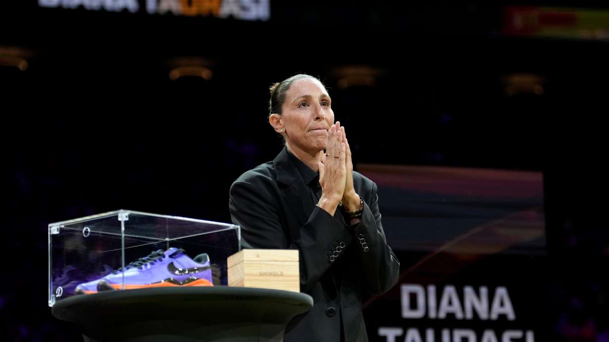 Retired WNBA Phoenix Mercury basketball player Diana Taurasi acknowledges the cheering crowd as she is honored during a halftime Ring of Honor ceremony Sunday, Aug. 16, 2026, in Phoenix.