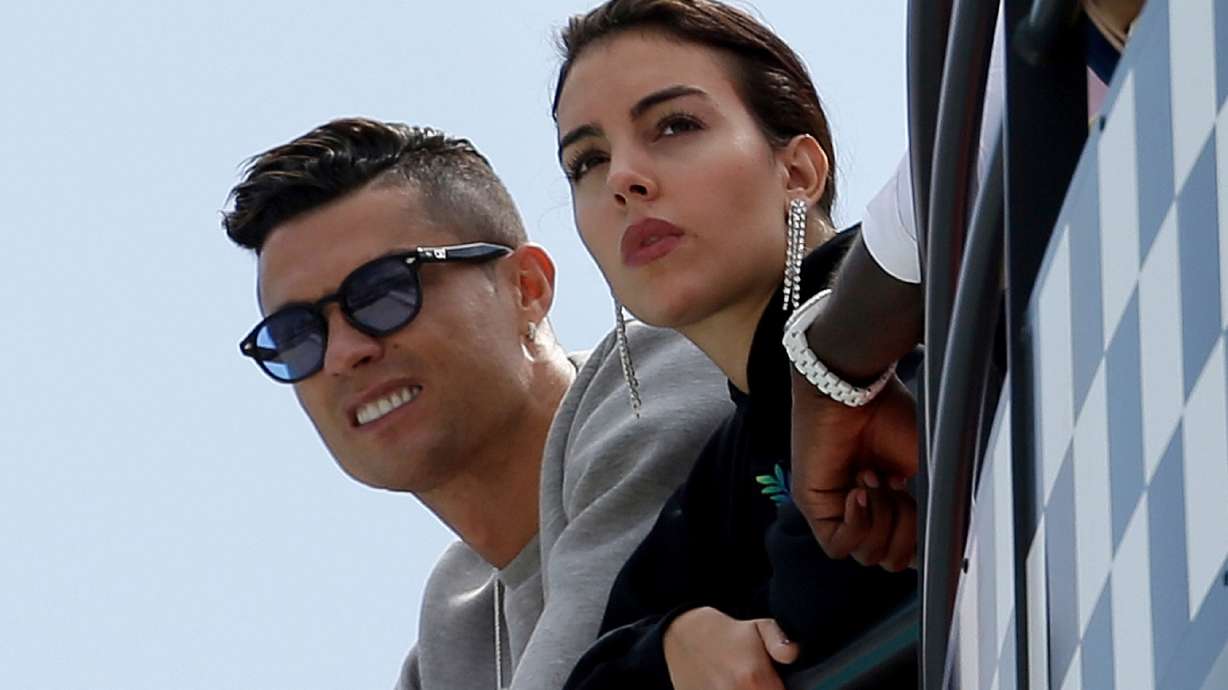 FILE - Cristiano Ronaldo, left, and his partner Georgina Rodriguez watch the second practice session at the Monaco racetrack, in Monaco, May 23, 2019.