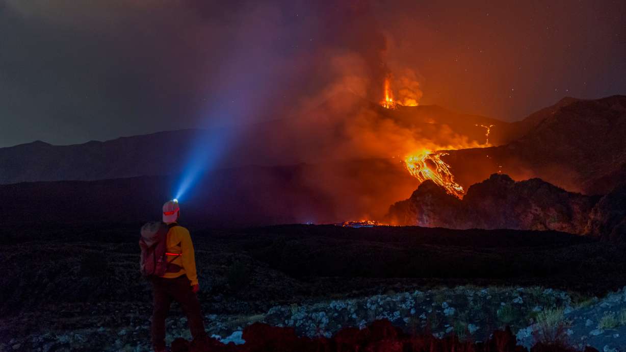 Eruptive activity continues on Mount Etna, where lava flows continue to descend on the slopes of the volcano, as seen from Mareneve near Catania, Italy, Thursday.