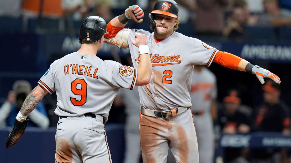 Baltimore Orioles' Gunnar Henderson (2) celebrates his two-run home run off Tampa Bay Rays pitcher Chris Roycroft with Tyler O'Neill (9) during the eighth inning of a baseball game Friday, Aug. 14, 2026, in St. Petersburg, Fla.