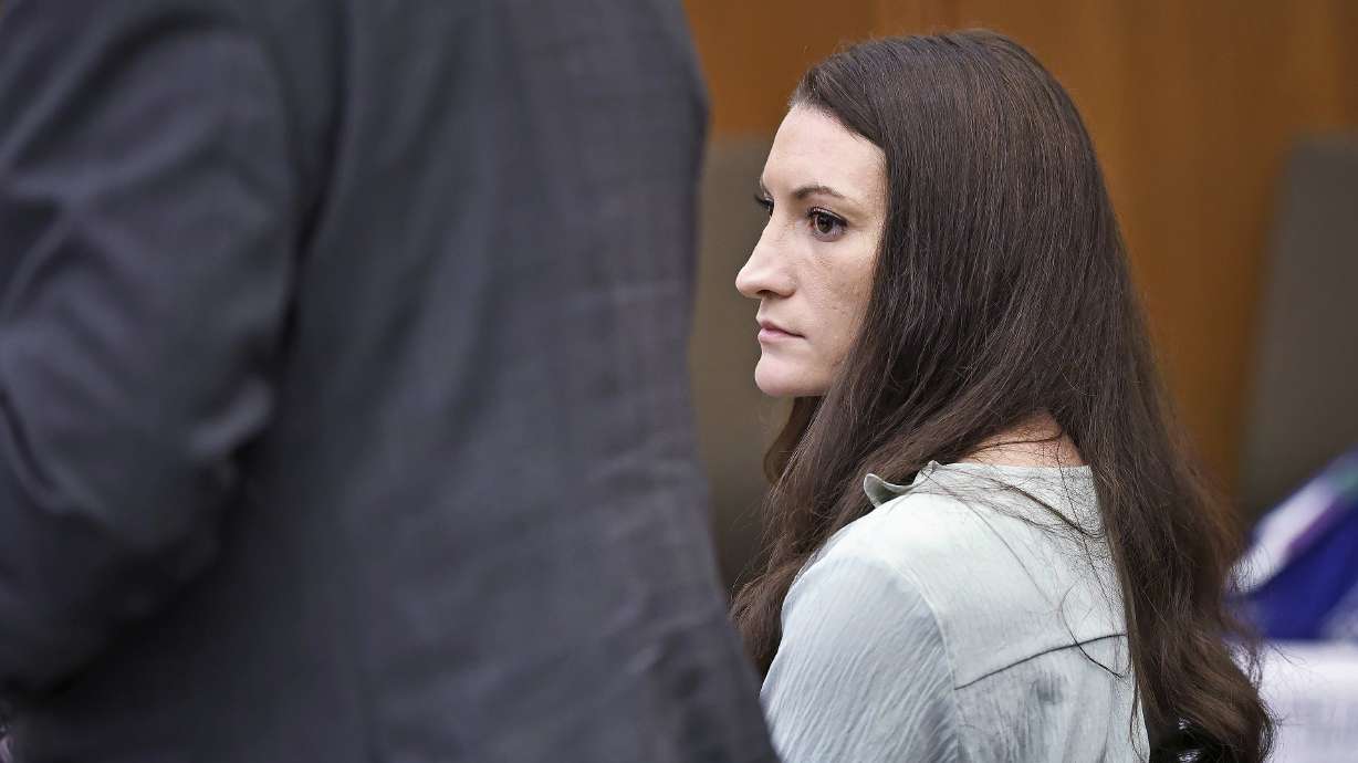 Lindsay Clancy watches the jury enter the room during her murder trial at Plymouth Superior Court in Plymouth, Mass., Monday. Clancy's mother and sister took the stand Monday to recount how they saw her become increasingly anxious, paranoid and suicidal in the months before she killed her three children.