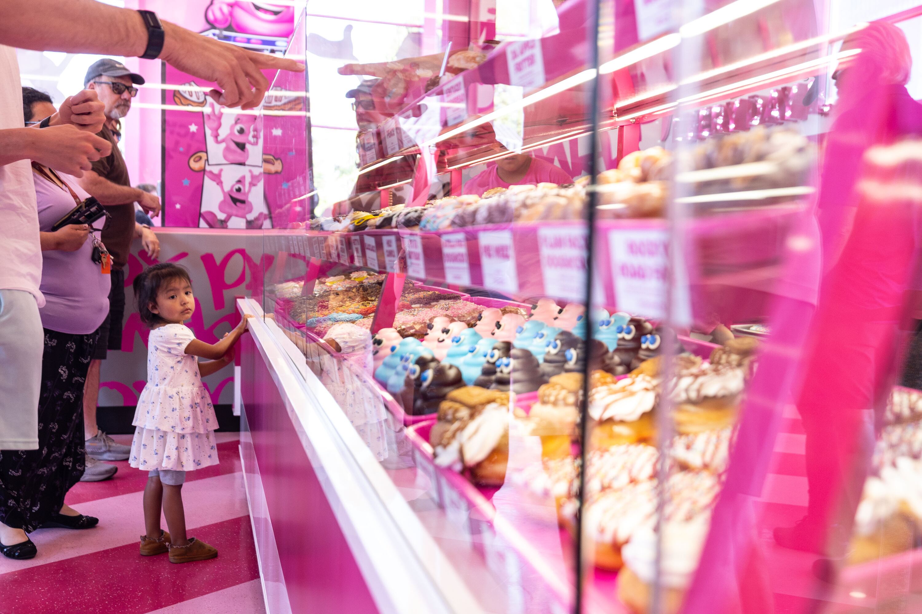 Customers line up for doughnuts at the new Pinkbox Doughnuts located at 10235 State St. in Sandy on Sunday.